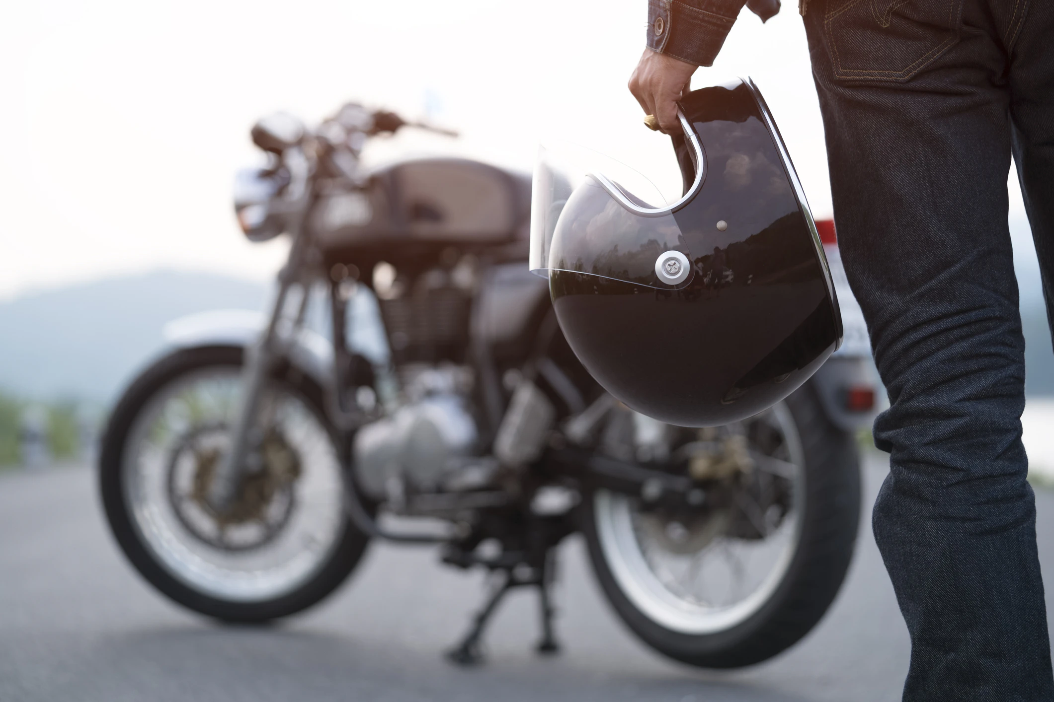 Biker holding helmet, preparing for ride