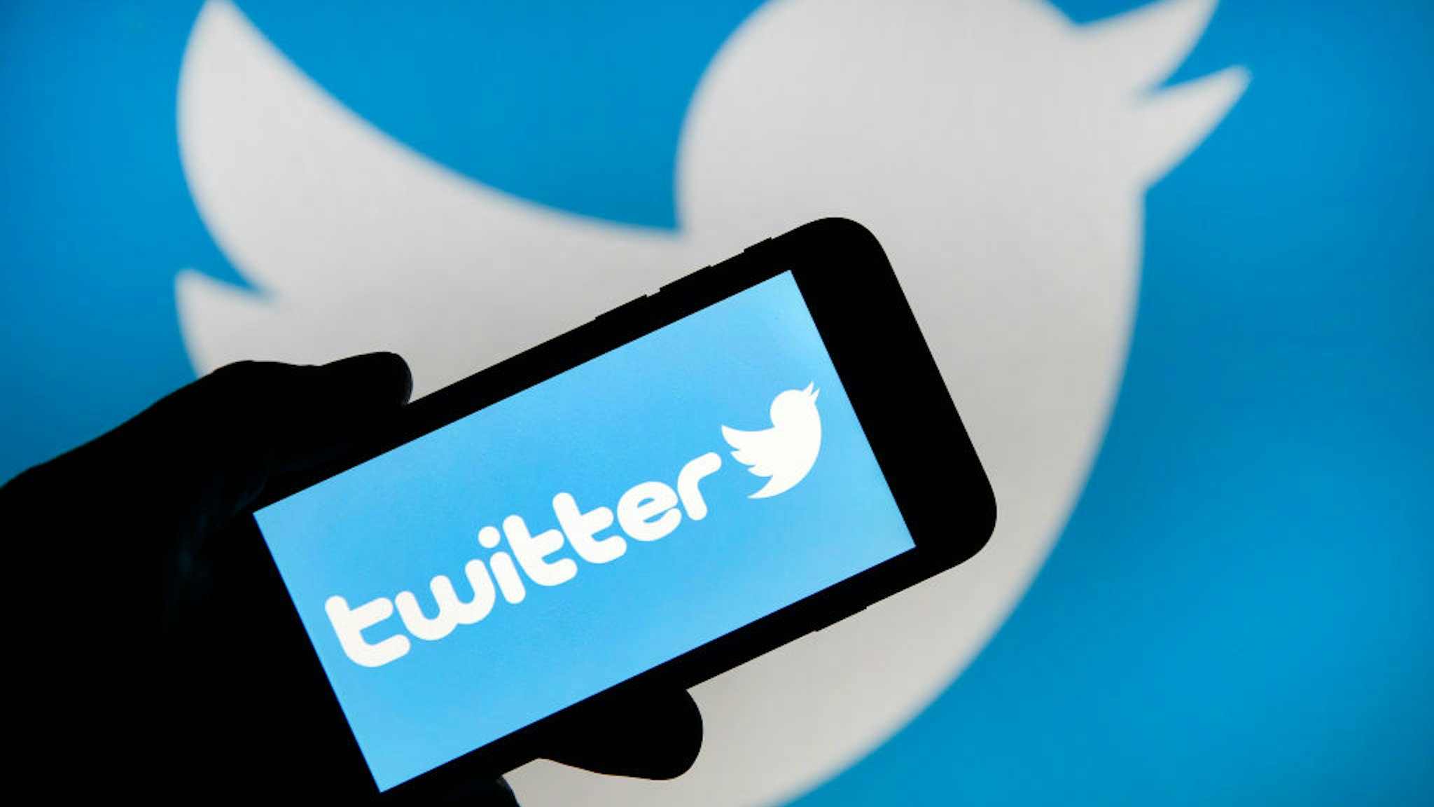 PARIS, FRANCE - FEBRUARY 07: In this photo illustration the Twitter logo is displayed on the screen of an iPhone in front of a computer screen displaying a Twitter logo on February 07, 2019 in Paris, France. Twitter today posted better than expected Wall Street results over the last three months of 2018, with net profit up 28% and revenue up 4%, but the stock is falling. After losing 5 million monthly users by the end of 2018, the social network Twitter decided to stop giving figures. In its financial results for the fourth quarter of 2018, the company explains that this announcement will take effect in the second quarter of 2019.