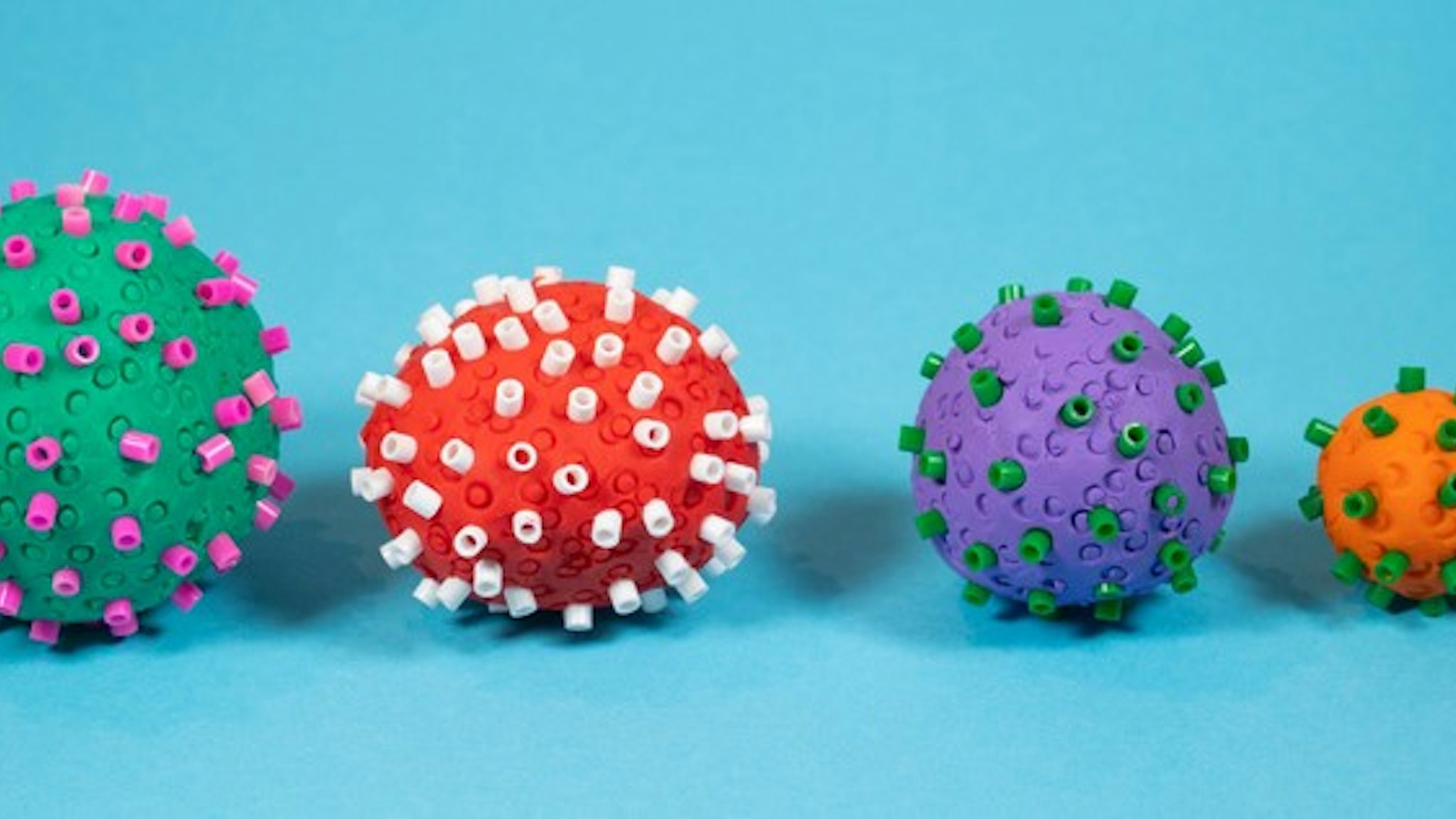 Close-up four different Coronavirus of different color. Creative concept.