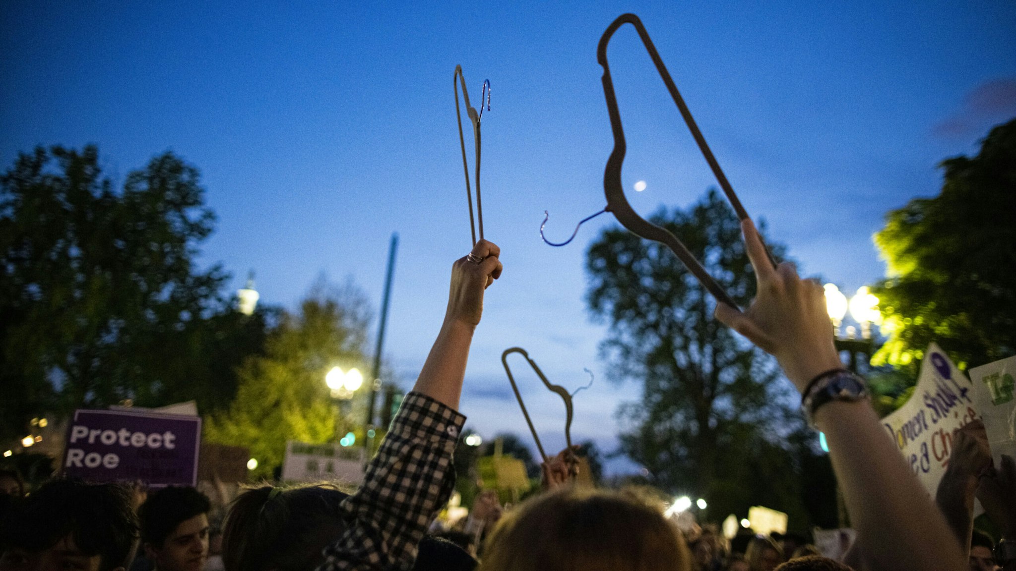Abortion rights demonstrators with hangers during a protest outside the U.S. Supreme Court in Washington, D.C., U.S., on Tuesday, May 3, 2022.