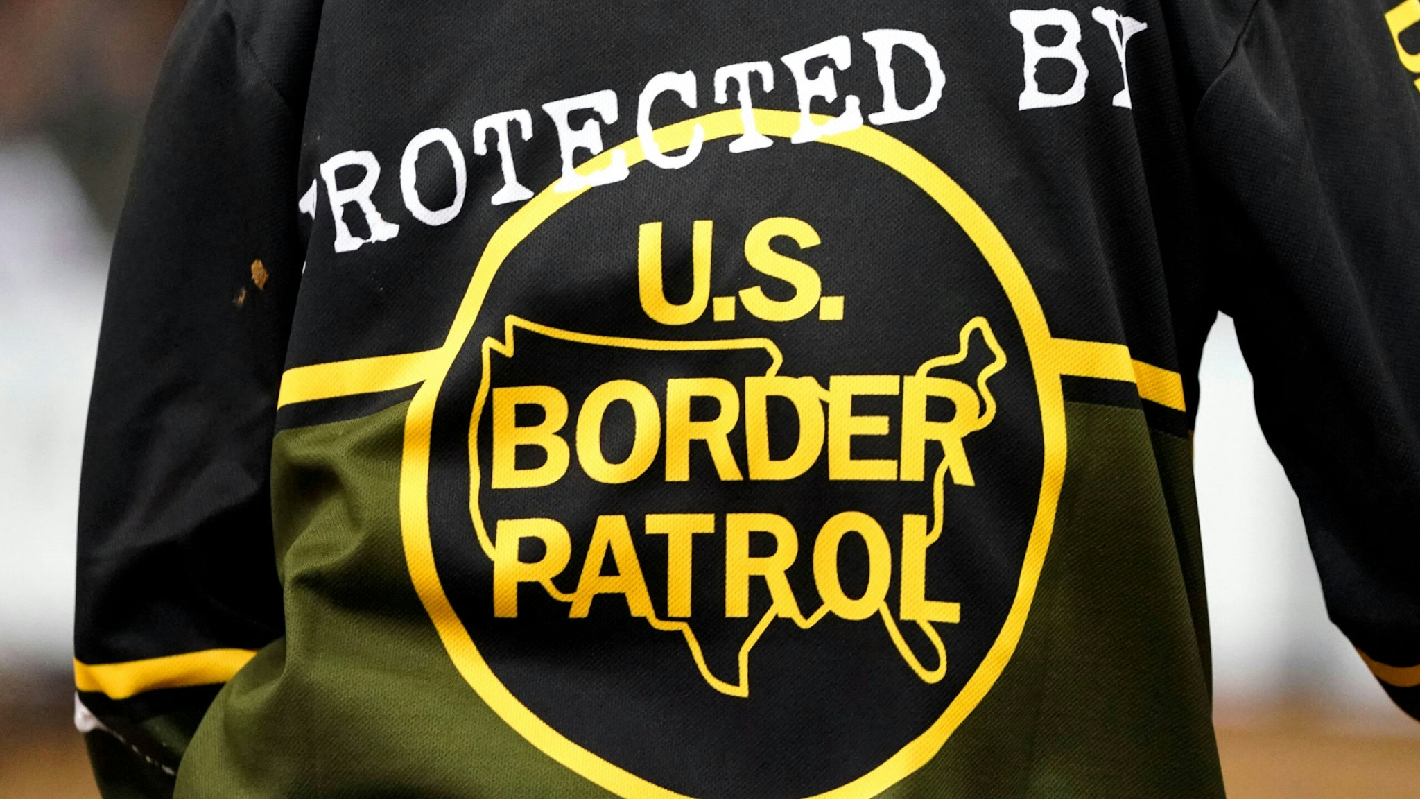 A rodeo ring Bullfighter wears a shirt with the message "Protected by US Border Patrol" during the PBR Unleash The Beast Monster Energy Buckoff at Madison Square Garden in New York, January 7, 2022.