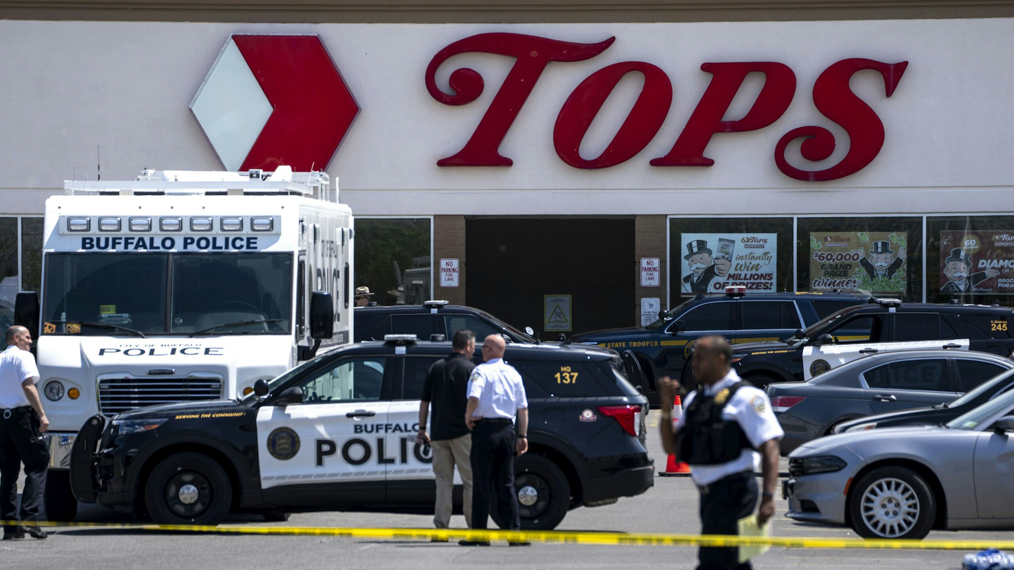 BUFFALO, NY - MAY 15: Law enforcement officials are seen at the scene of a mass shooting at Tops Friendly Market at Jefferson Avenue and Riley Street on Sunday, May 15, 2022 in Buffalo, NY. The fatal shooting of 10 people at a grocery store in a historically Black neighborhood of Buffalo by a young white gunman is being investigated as a hate crime and an act of racially motivated violent extremism, according to federal officials.