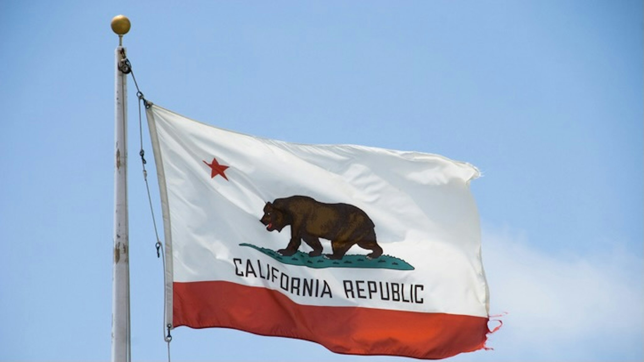 Low Angle View Of California Flag Against Clear Sky - stock photo Alex Reitter / EyeEm via Getty Images