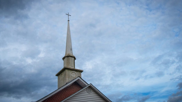 A weathered church steeple in a small American town.