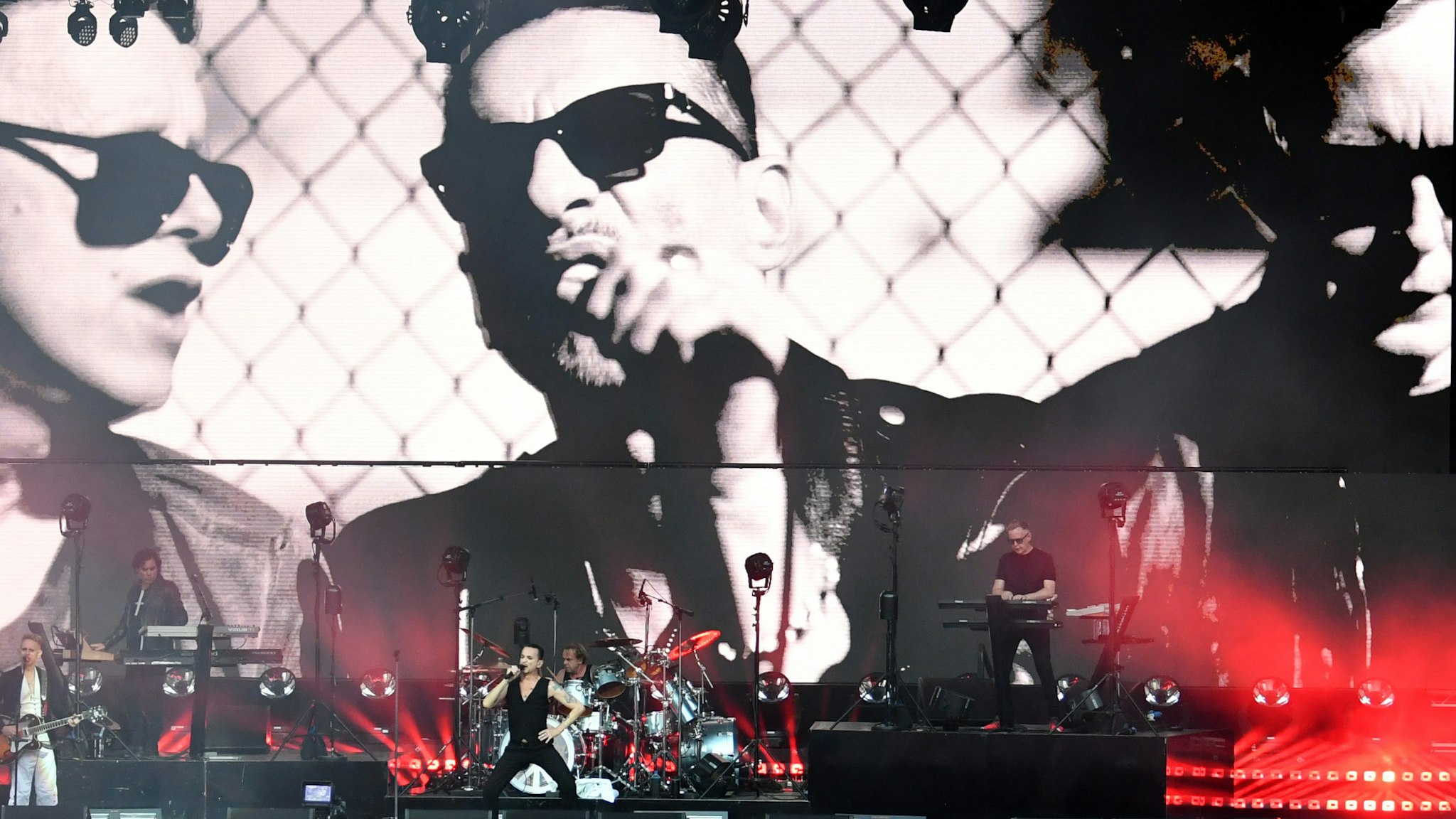 Dave Gahan, singer and frontman, Martin Gore (keyboard, guitars) and Andy Fletcher (keyboard) of the band "Depeche Mode" performing during the last concert of the band's "Global Spirit" world tour in the Waldbuehne, while a they appear in a videoclip in the background.