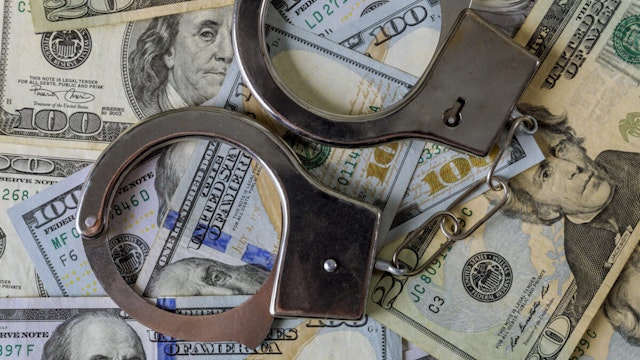 US dollar banknotes money cash corruption, dirty money financial crime and metal police handcuffs