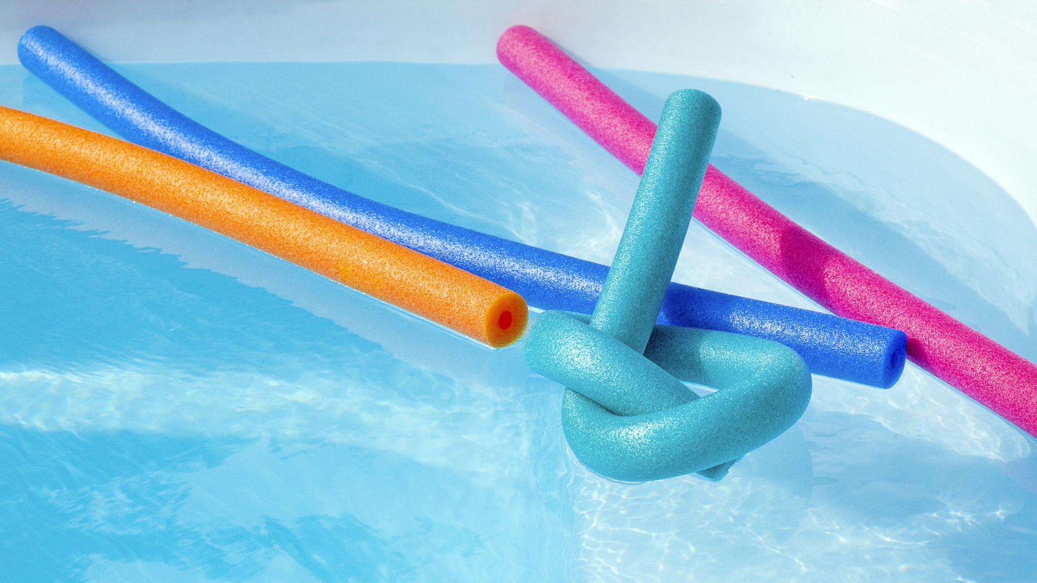 Colorful plastic noodle in a swimming pool. Nobody.