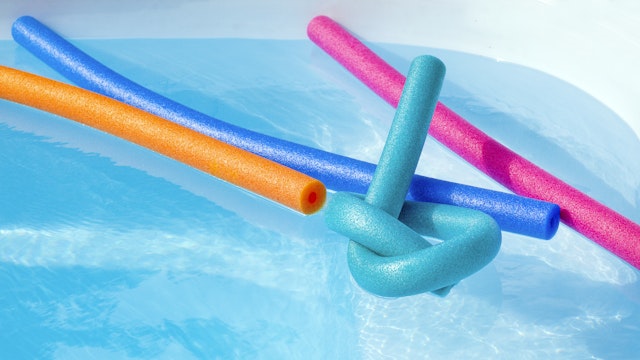 Colorful plastic noodle in a swimming pool. Nobody.