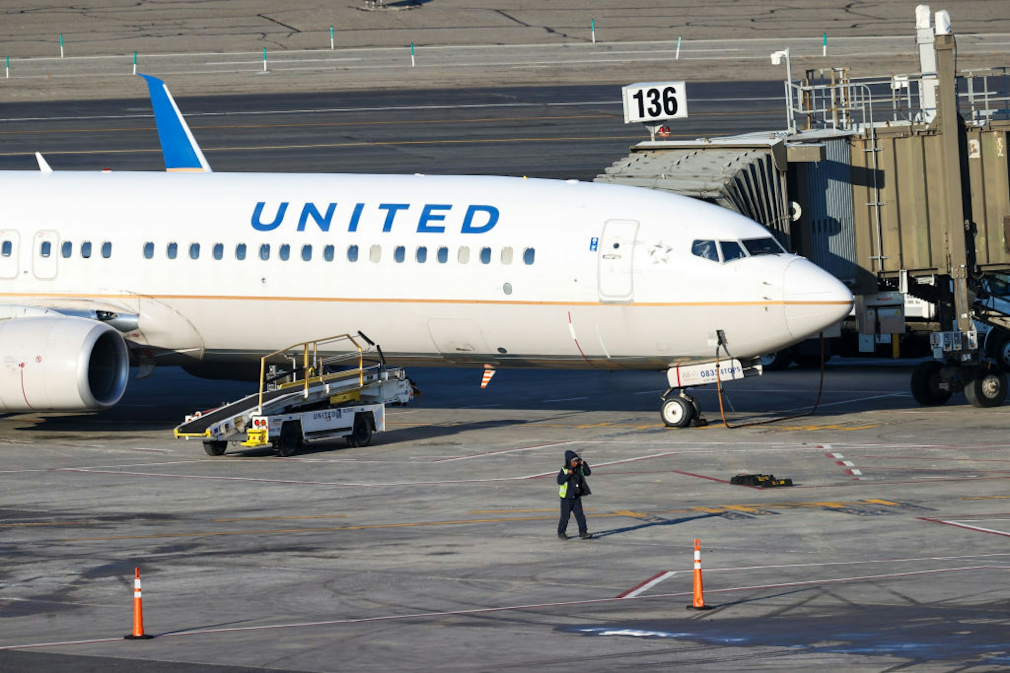 A United Airlines employee was beaten up by a former NFL player at Newark Airport in an incident caught on video.