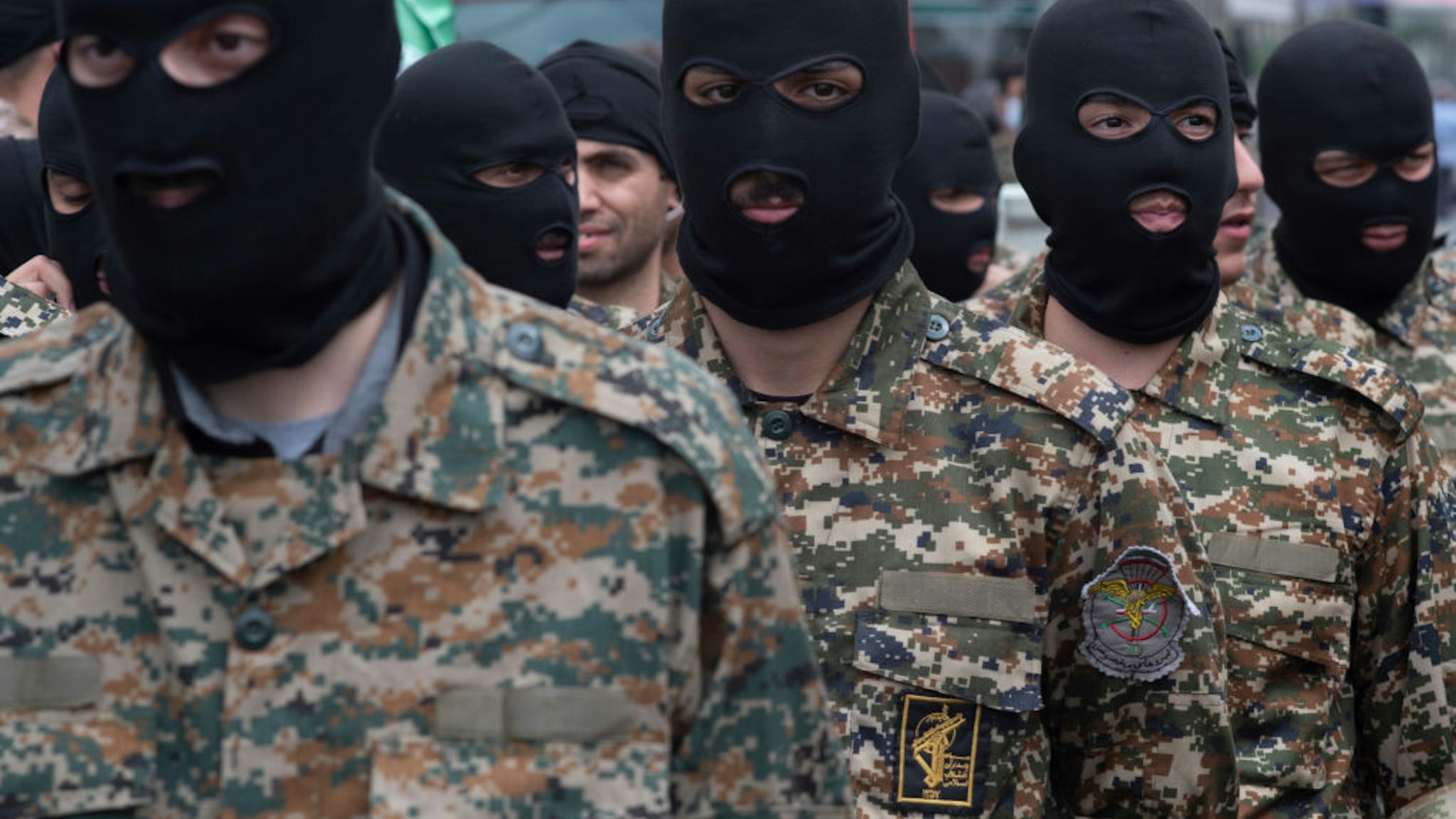 Islamic Revolutionary Guard Corps (IRGC) military personnel stand guard on an avenue in downtown Tehran.