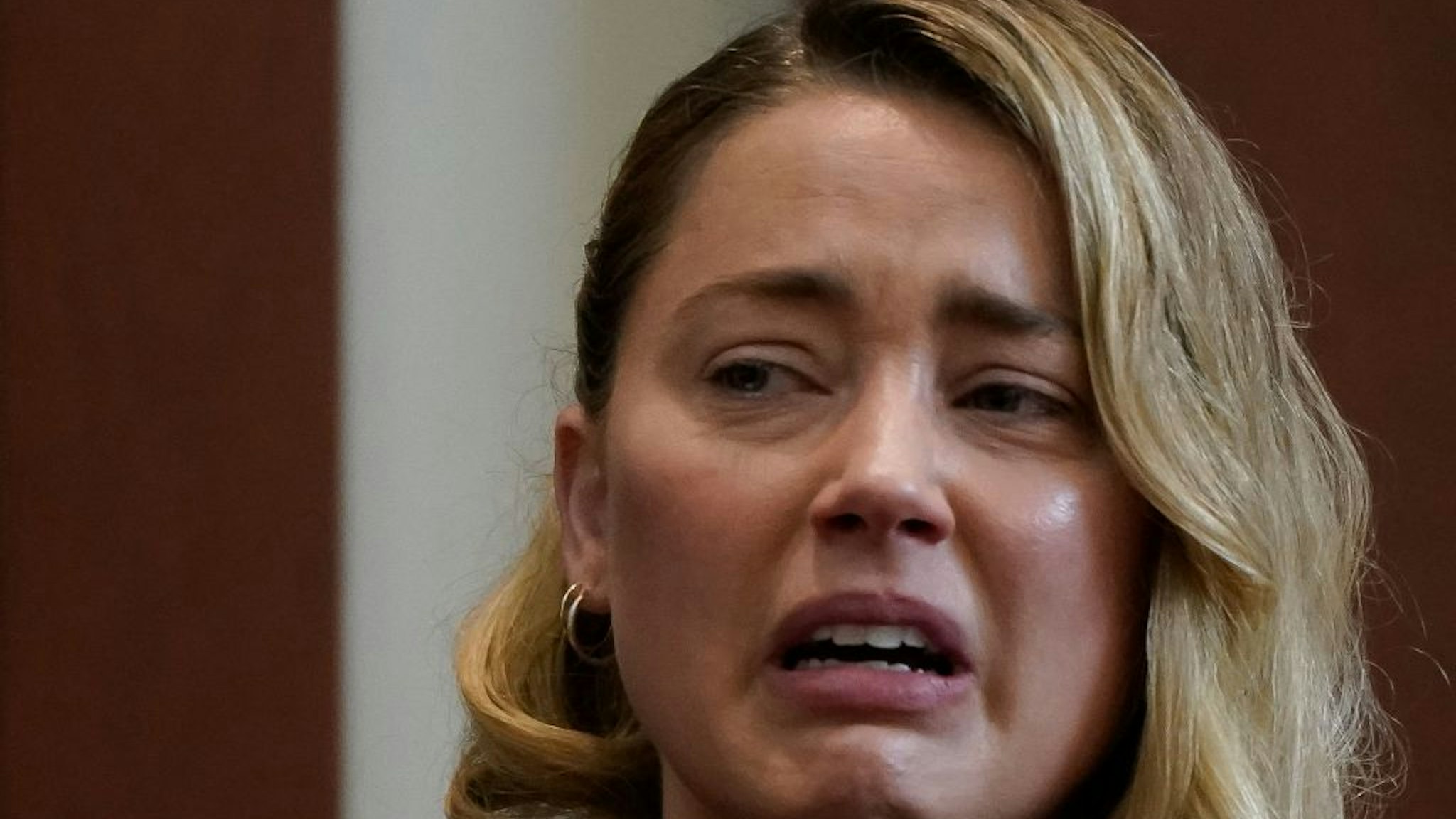 Actor Amber Heard testifies about the first time her ex-husband, actor Johnny Depp hit her, at Fairfax County Circuit Court during a defamation case against her by Depp in Fairfax, Virginia, on May 4, 2022.