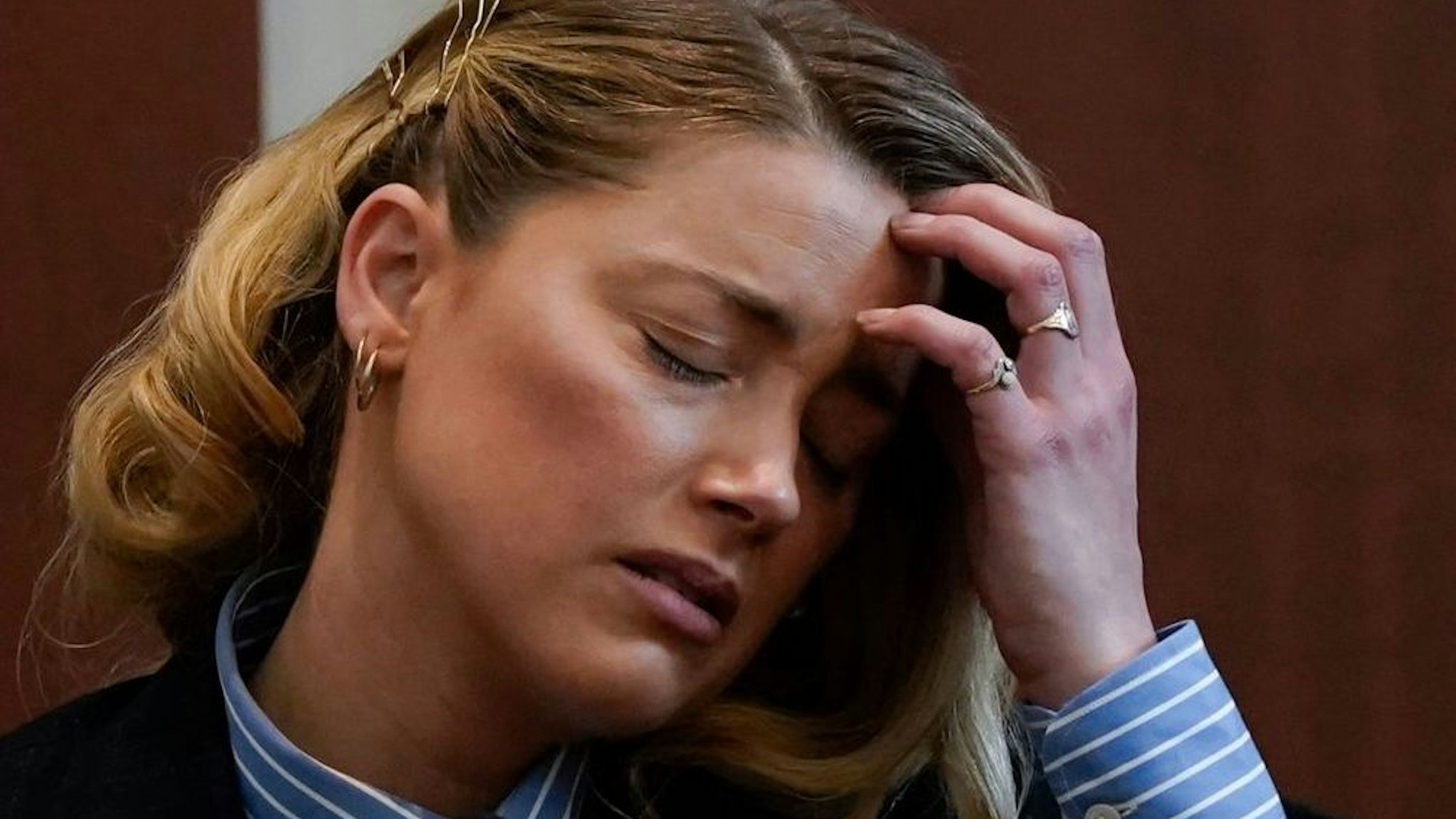 Actor Amber Heard testifies about the first time she says her ex-husband, actor Johnny Depp hit her, at Fairfax County Circuit Court during a defamation case against her by Depp in Fairfax, Virginia, on May 4, 2022.