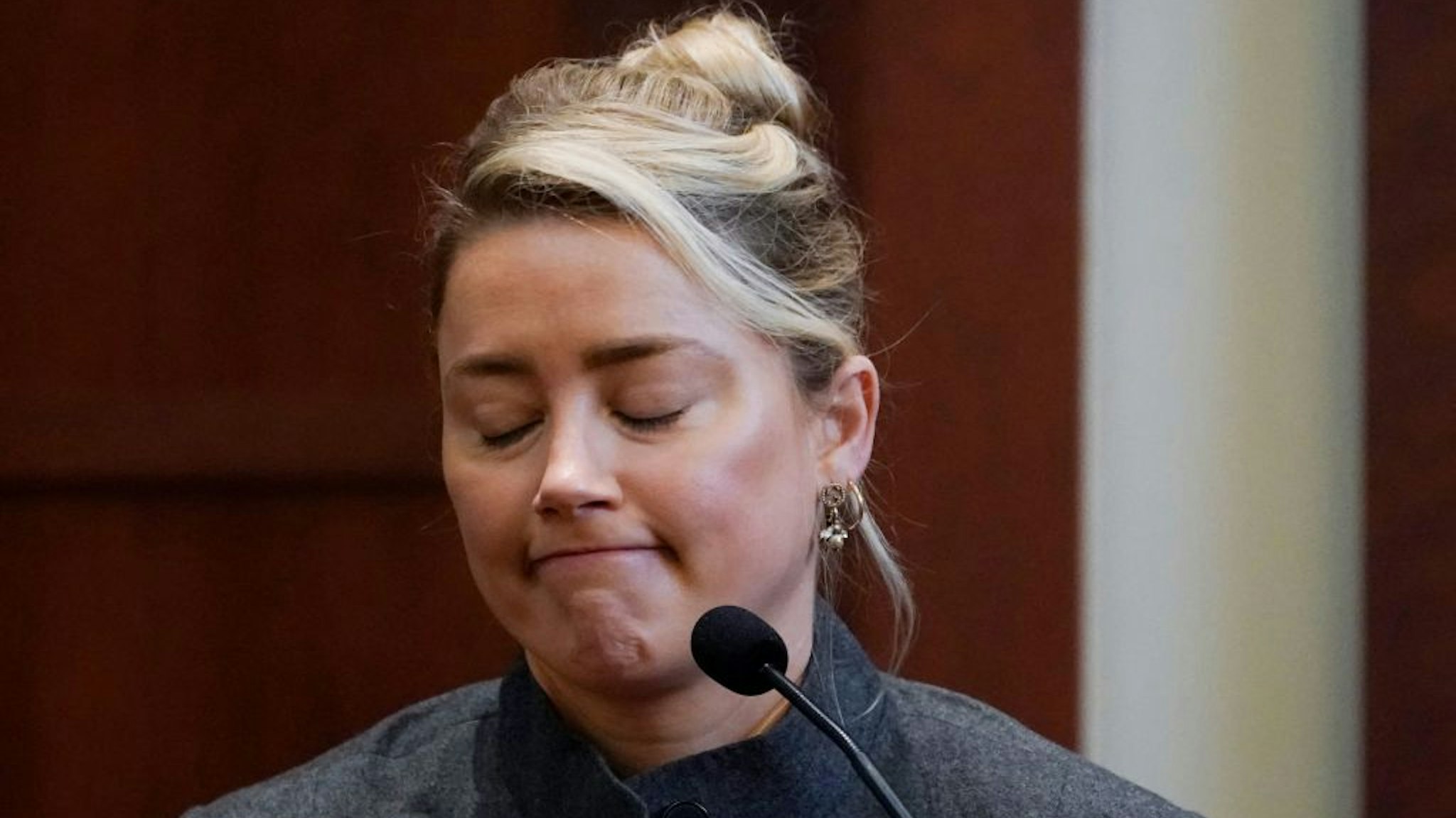Actor Amber Heard testifies in the courtroom at the Fairfax County Circuit Courthouse in Fairfax, Virginia, on May 16, 2022. - Actor Johnny Depp sued his ex-wife Amber Heard for libel in Fairfax County Circuit Court after she wrote an op-ed piece in The Washington Post in 2018 referring to herself as a "public figure representing domestic abuse." (Photo by Steve Helber / POOL / AFP) (Photo by STEVE HELBER/POOL/AFP via Getty Images)