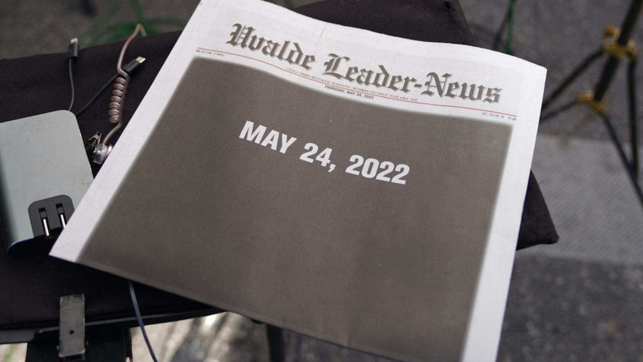 The front page of the local newspaper is seen in the media area outside the Robb Elementary School in Uvalde, Texas on May 26, 2022. - Grief at the massacre of 19 children at the elementary school in Texas spilled into confrontation on May 25, as angry questions mounted over gun control -- and whether this latest tragedy could have been prevented. The tight-knit Latino community of Uvalde on May 24 became the site of the worst school shooting in a decade, committed by a disturbed 18-year-old armed with a legally bought assault rifle. (Photo by allison dinner / AFP) (Photo by ALLISON DINNER/AFP via Getty Images)