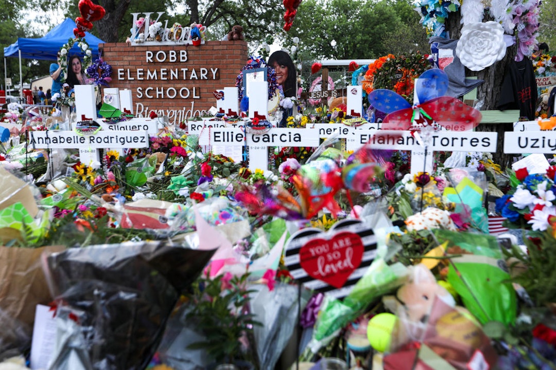 TEXAS, USA - MAY 30: People visit a memorial for the 19 children and two adults killed on May 24th during a mass shooting at Robb Elementary School on May 30, 2022 in Uvalde, Texas. (Photo by Yasin Ozturk/Anadolu Agency via Getty Images)