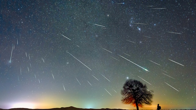 The Geminid meteor shower on December 13, 2020 was photographed in the Kubuqi Desert of Inner Mongolia, China, on a very cold night of minus 20 degrees