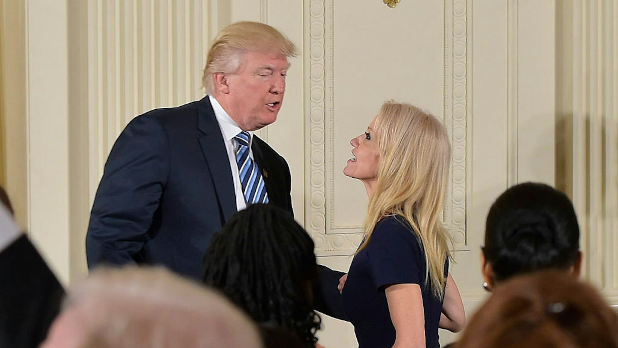 US President Donald Trump speaks with Counselor to the President Kellyanne Conway after the swearing in of the White House senior staff at the White House on January 22, 2017, in Washington, DC. / AFP / MANDEL NGAN (Photo credit should read MANDEL NGAN/AFP via Getty Images)
