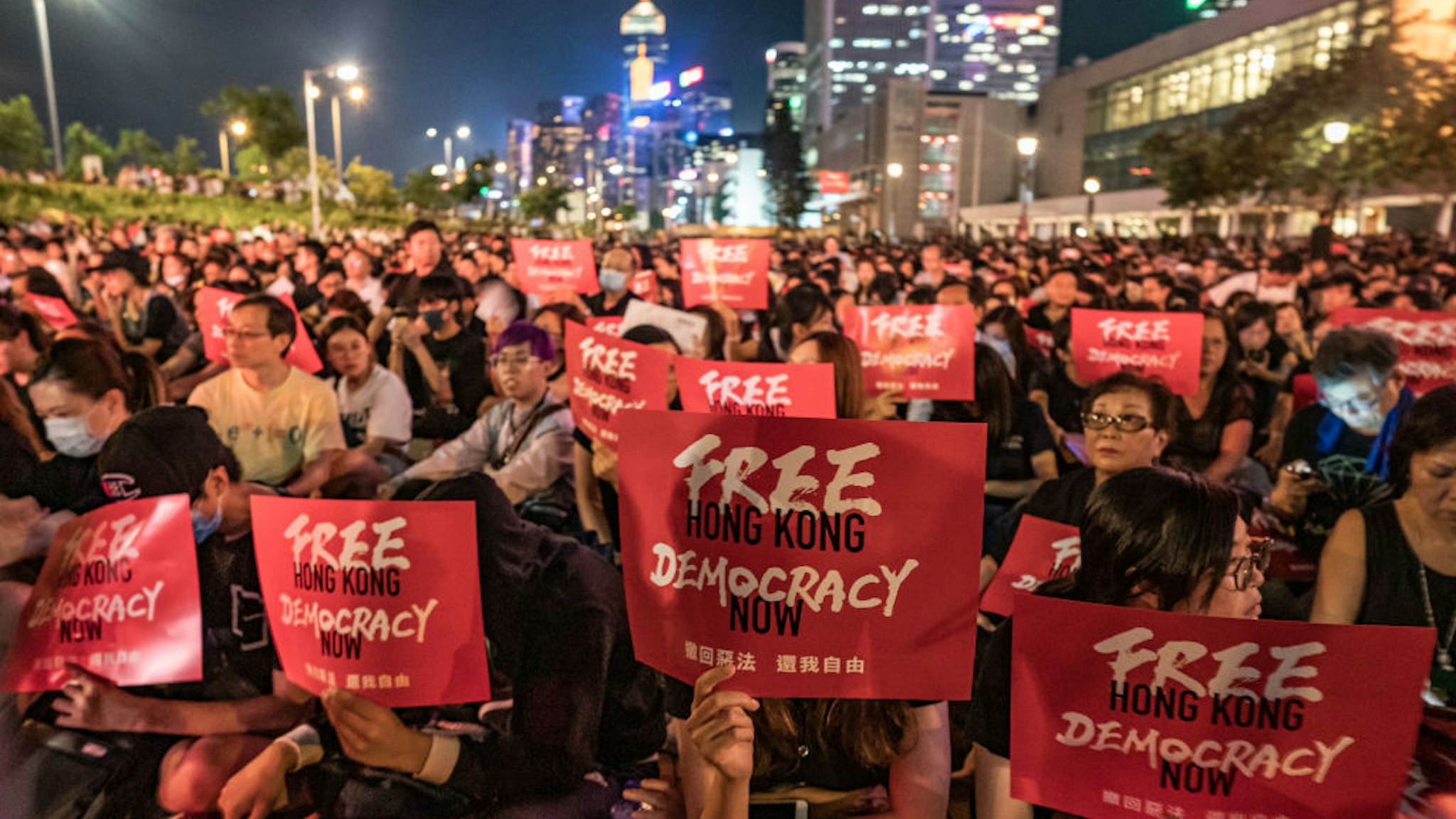 HONG KONG, HONG KONG - JUNE 26: Protesters hold placards as they take part in a rally against the extradition bill ahead of 2019 G20 Osaka summit at Edinburgh Place in Central district on June 26, 2019 in Hong Kong, China. Leaders from the Group of 20 nations are scheduled to gather this week for the G20 summit in Osaka, Japan.