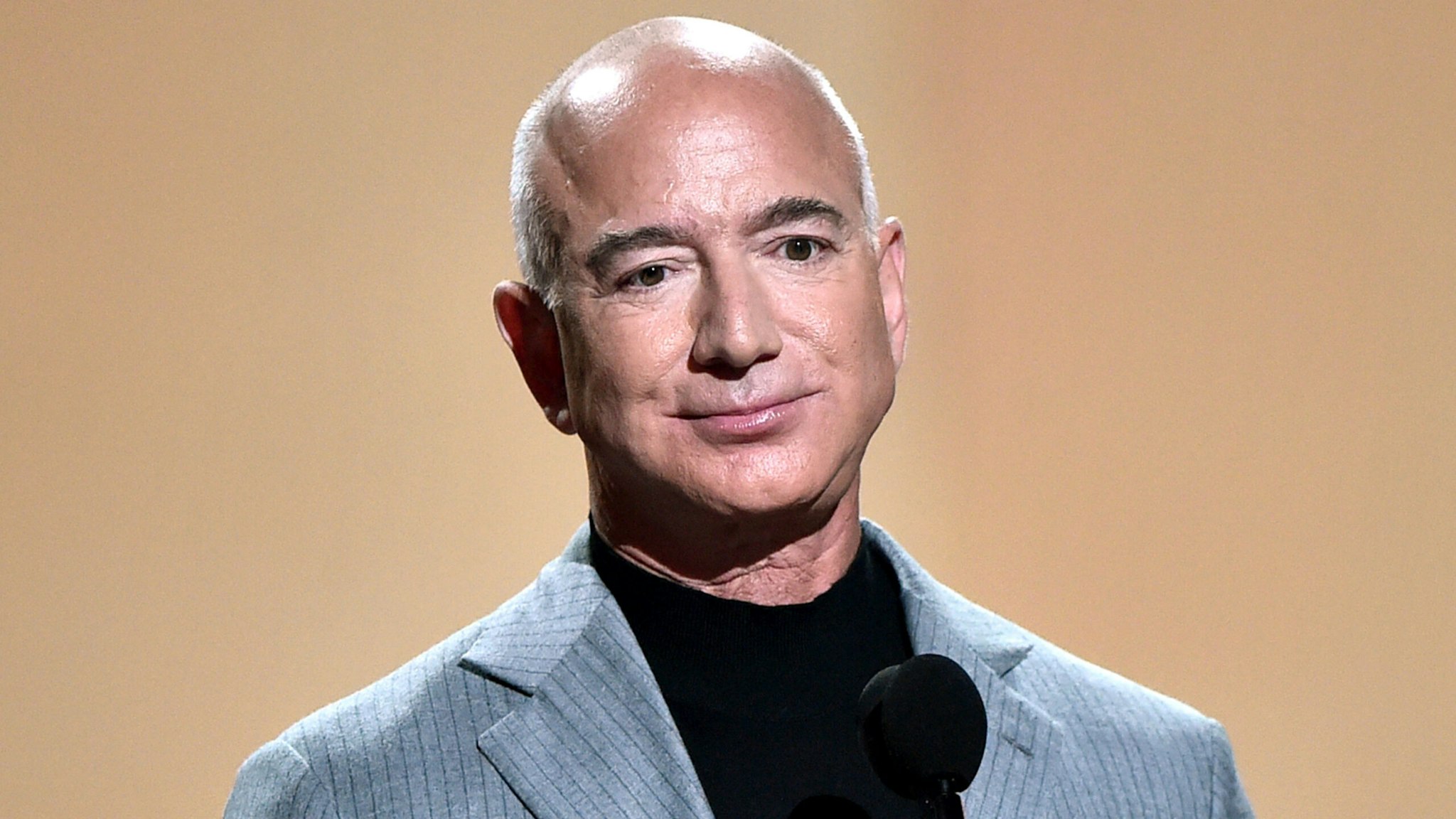 SANTA MONICA, CALIFORNIA - DECEMBER 07: 2021 PEOPLE'S CHOICE AWARDS -- Pictured: Jeff Bezos speaks on stage during the 2021 People's Choice Awards held at Barker Hangar on December 7, 2021 in Santa Monica, California.