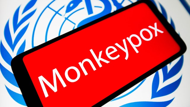 UKRAINE - 2022/05/21: In this photo illustration, the word Monkeypox is seen on the screen of a smartphone with the World Health Organization (WHO) logo in the background.