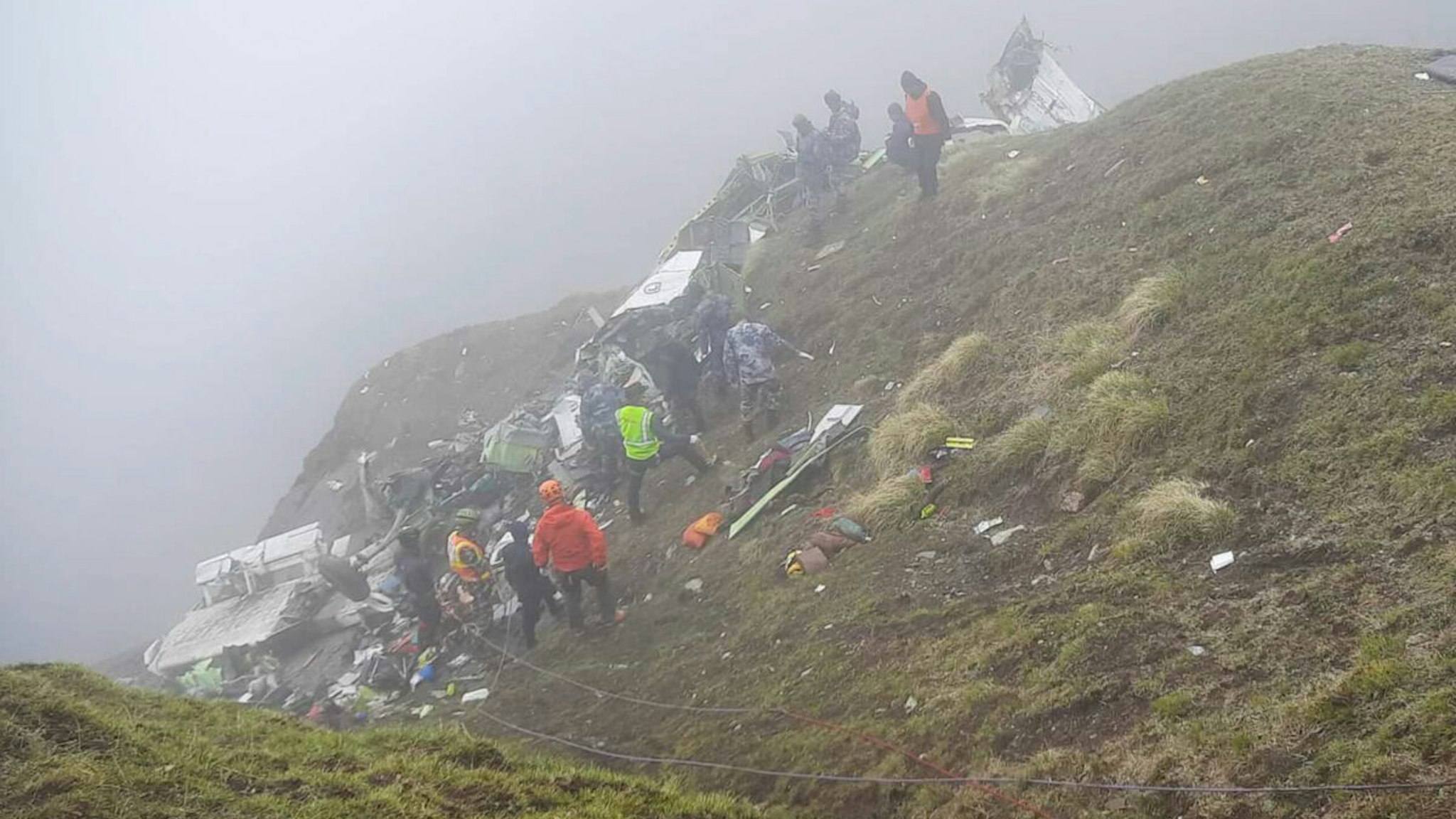 Armed Police Force, Rescue team carry the bodies of the passengers from the crash site of Tara Air at the hilly area of Thasang village of Mustang district in Nepal on May 30, 2022