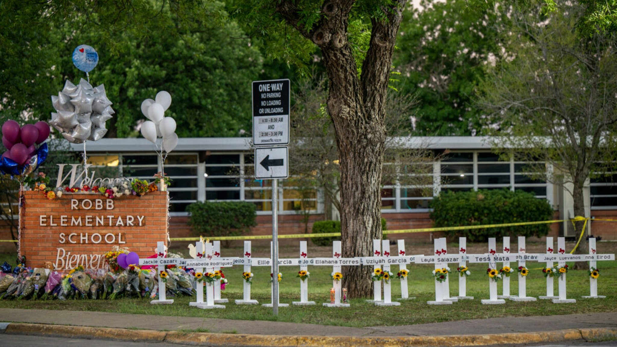 A memorial is seen surrounding the Robb Elementary School sign following the mass shooting at Robb Elementary School on May 26, 2022 in Uvalde, Texas
