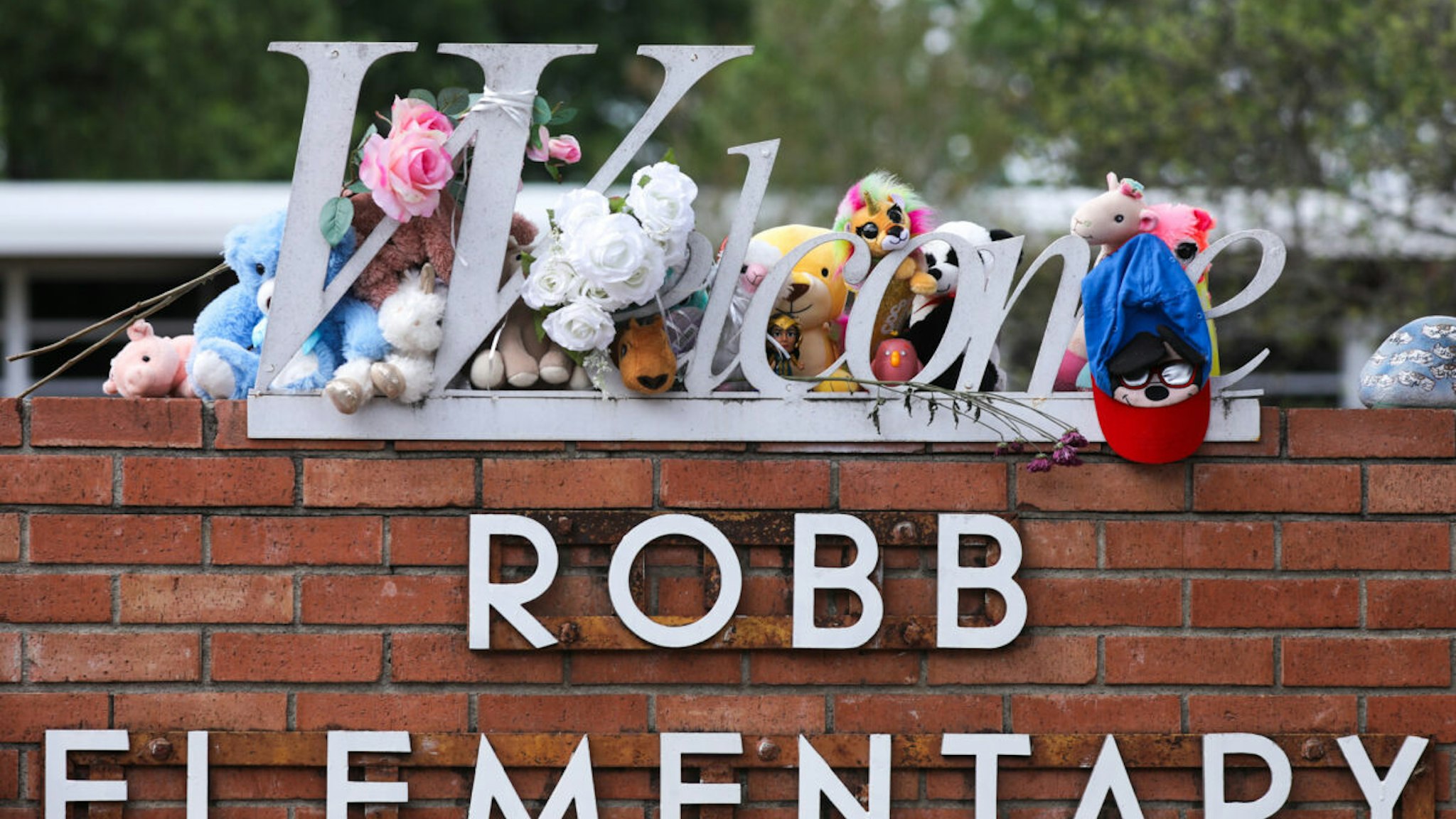 People visit a memorial for the 19 children and two adults killed on May 24th during a mass shooting at Robb Elementary School on May 30, 2022 in Uvalde, Texas