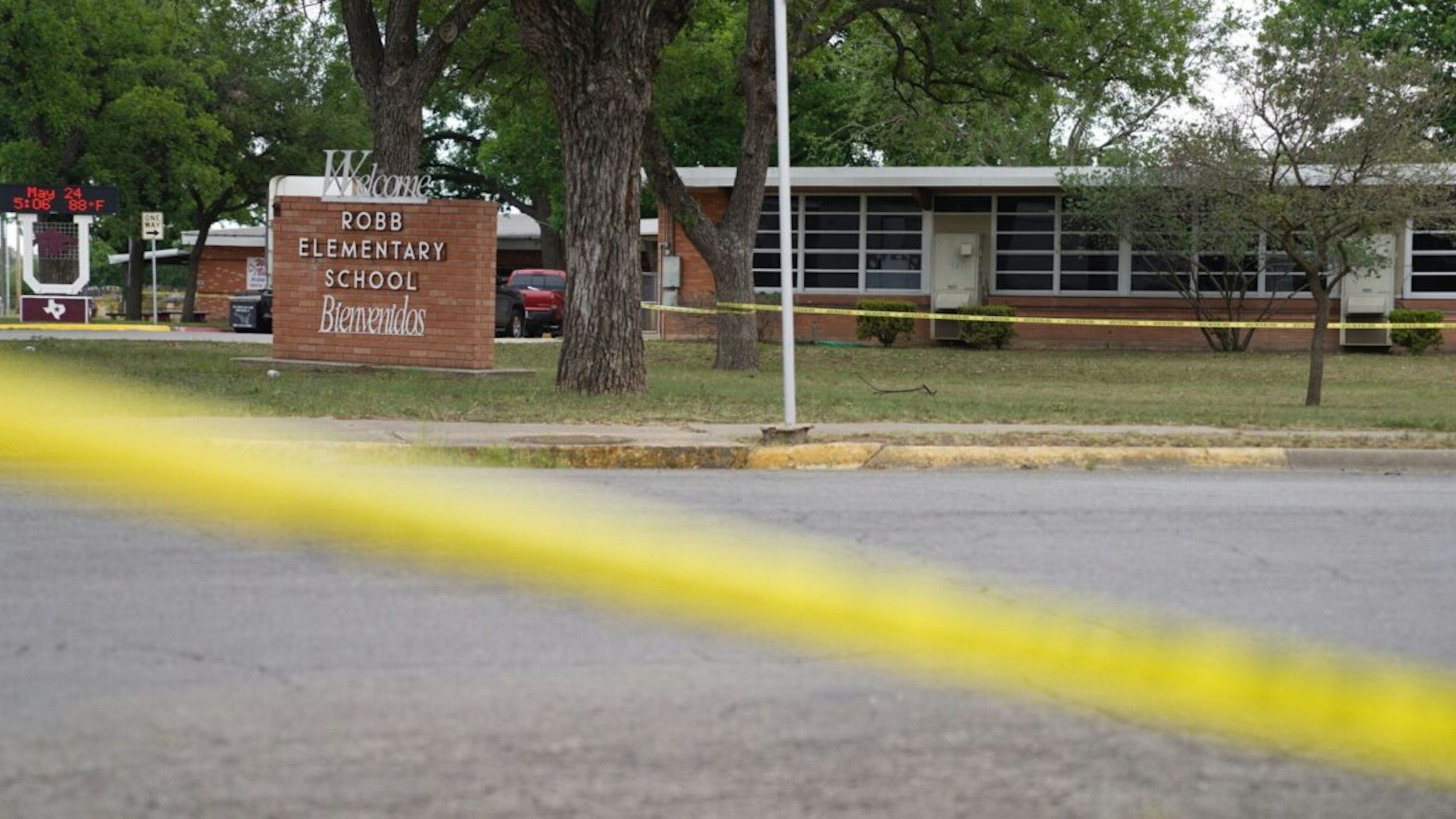 Sheriff crime scene tape is seen outside of Robb Elementary School as State troopers guard the area in Uvalde, Texas, on May 24, 2022