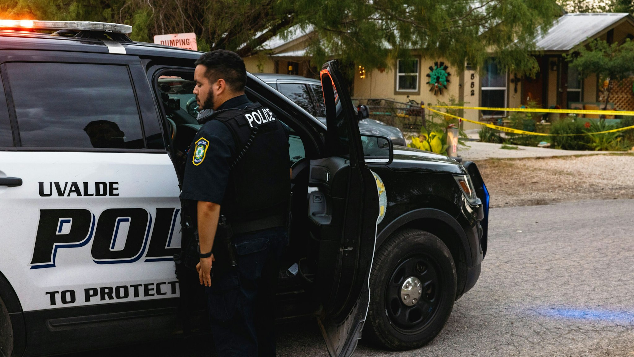 UVALDE, TX - MAY 24: Uvalde Police gather outside the home of suspected gunman 18-year-old Salvador Ramos on May 24, 2022 in Uvalde, Texas. According to reports, Ramos killed 19 students and 2 adults in a mass shooting at Robb Elementary School before being fatally shot by law enforcement.