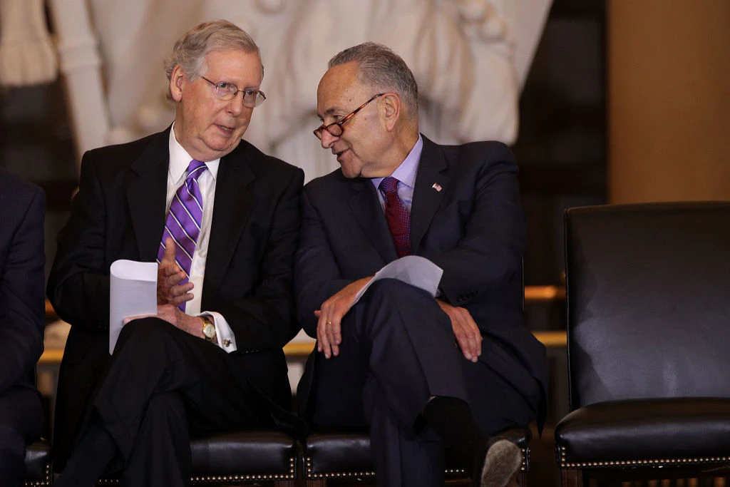 WASHINGTON, DC - OCTOBER 25: U.S. U.S. Senate Majority Leader Sen. Mitch McConnell (R-KY) (L) chats with Senate Minority Leader Sen. Chuck Schumer (D-NY) (R) during a Congressional Gold Medal presentation ceremony October 25, 2017 at the U.S. Capitol Visitor Center in Washington, DC. The medal is to honor Filipino veterans of World War II for their service and sacrifice during the war.