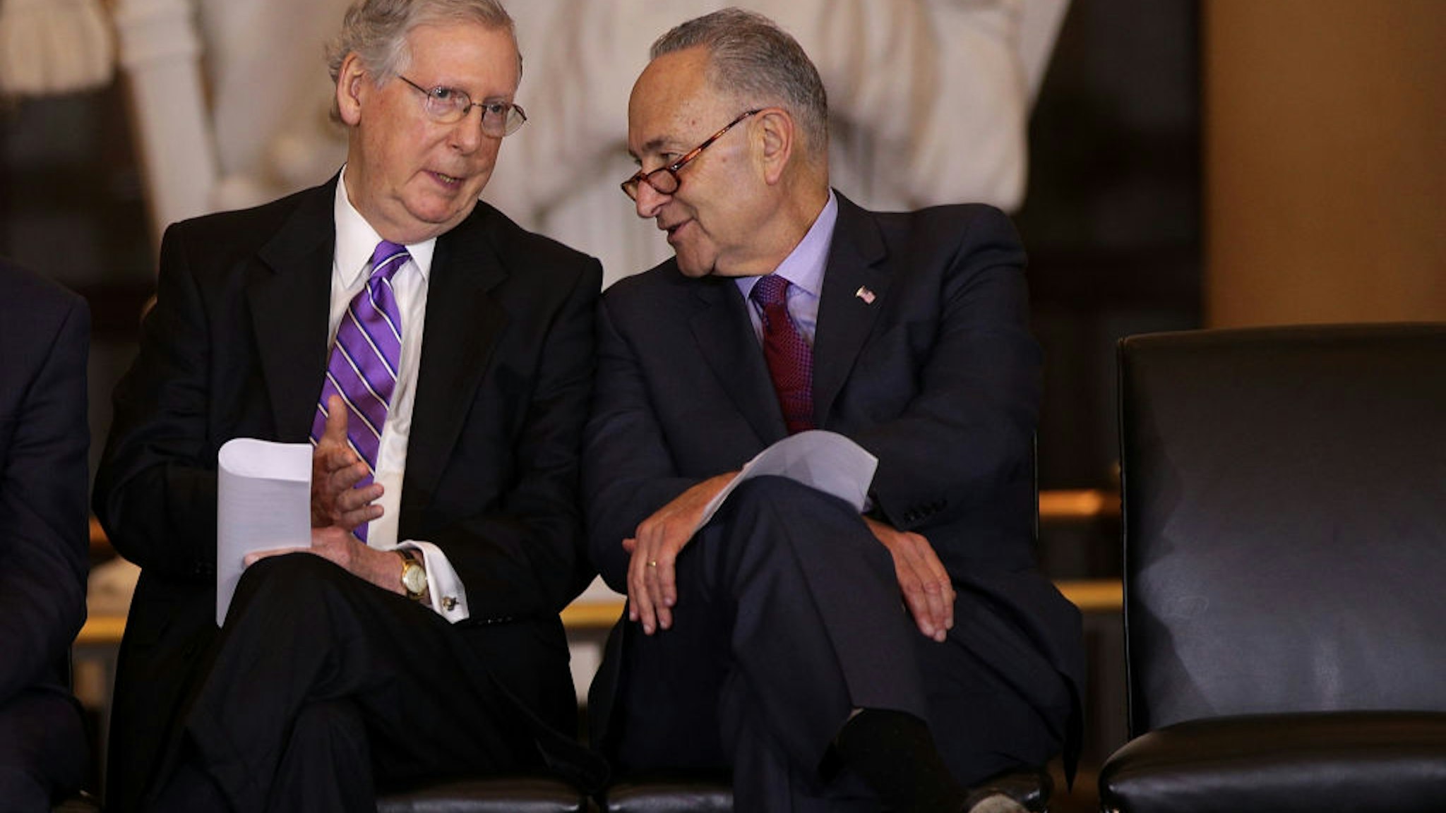 WASHINGTON, DC - OCTOBER 25: U.S. U.S. Senate Majority Leader Sen. Mitch McConnell (R-KY) (L) chats with Senate Minority Leader Sen. Chuck Schumer (D-NY) (R) during a Congressional Gold Medal presentation ceremony October 25, 2017 at the U.S. Capitol Visitor Center in Washington, DC. The medal is to honor Filipino veterans of World War II for their service and sacrifice during the war.
