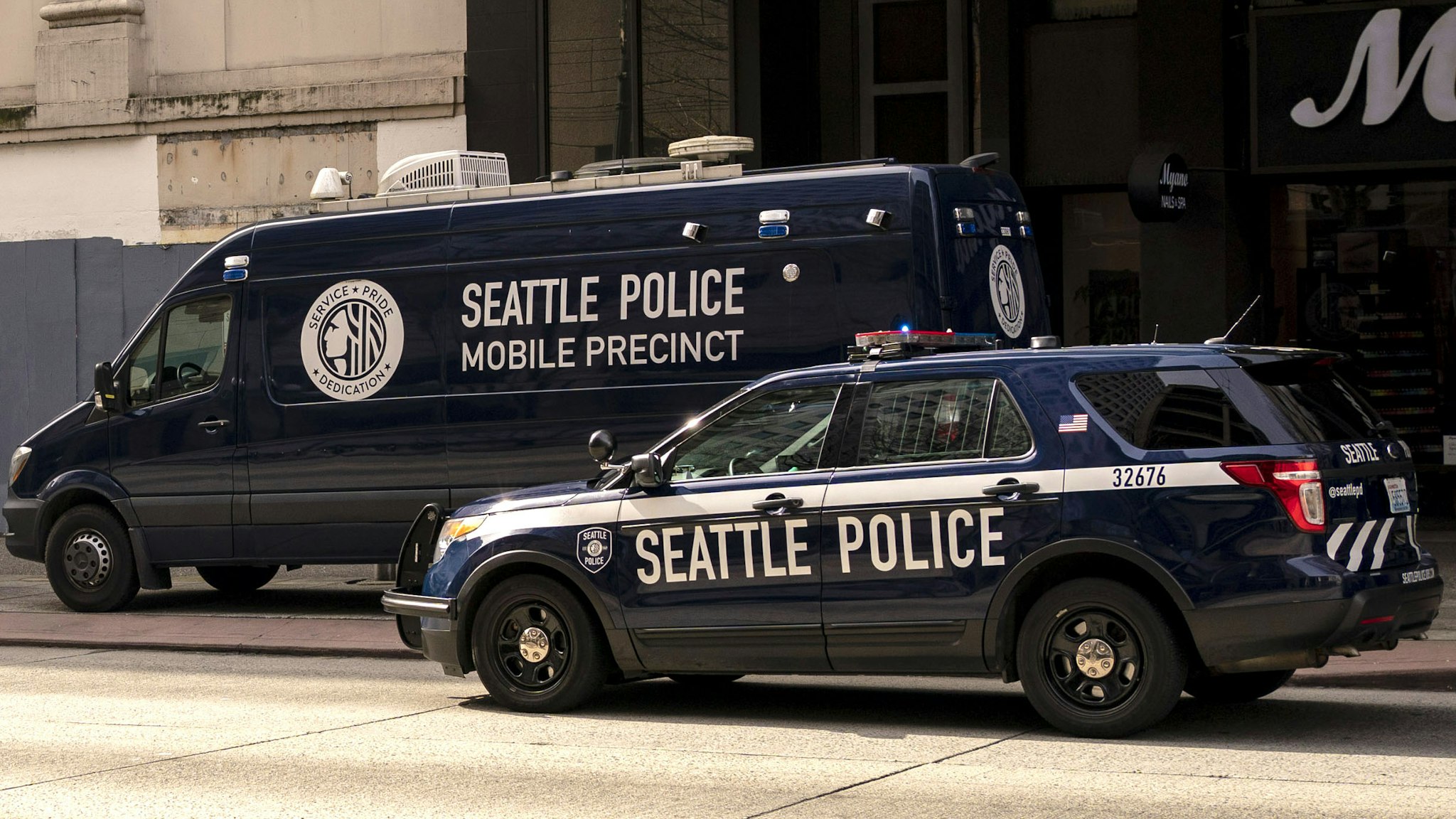 Seattle Police Department vehicles surround a mobile precinct unit on Third Avenue in downtown Seattle, Washington, U.S., on Thursday, March 24, 2022. Amazon is temporarily shuttering an office in the area as police increase their presence downtown. Seattle's new mayor, Bruce Harrell, swept into office on a law-and-order platform that also pledged to stem rising homelessness, crime has instead worsened downtown and the area's post-Covid rebound is lagging behind other parts of the city.