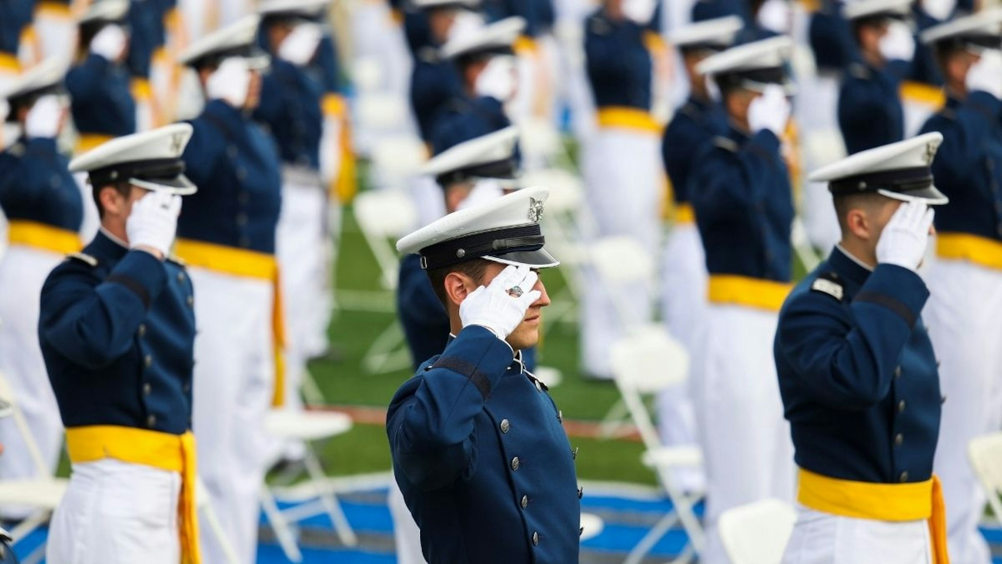 Members of the United States Air Force Academy Class of 2021 salute during their graduation ceremony at Falcon Stadium on May 26, 2021 in Colorado Springs, Colorado.