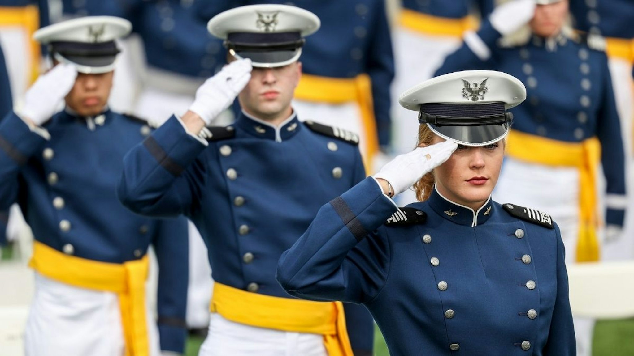 Members of the United States Air Force Academy Class of 2021 salute during their graduation ceremony at Falcon Stadium on May 26, 2021 in Colorado Springs, Colorado.
