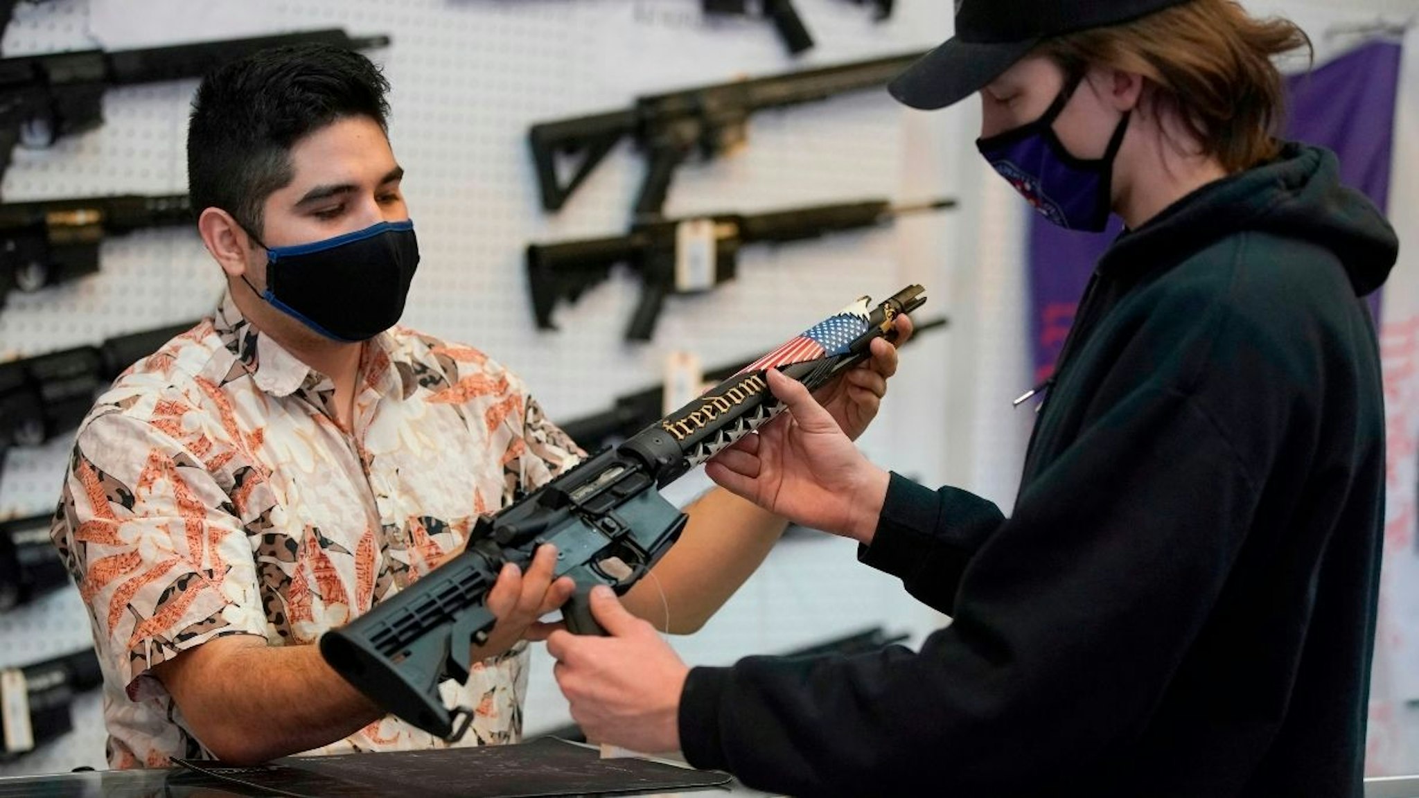 A customer looks at a custom made AR-15 style rifle at Davidson Defense in Orem, Utah on February 4, 2021.