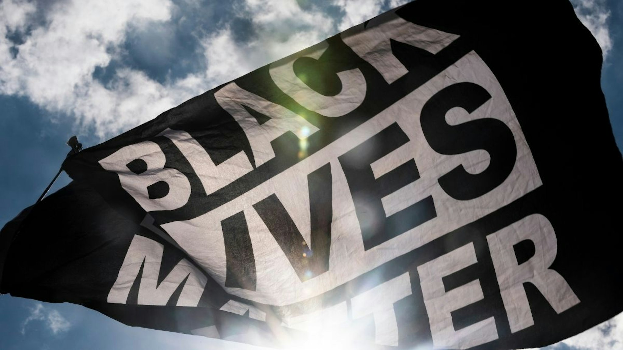 A Black Lives Matter flag waves during a demonstration outside the First Police Precinct Station on June 13, 2020 in Minneapolis, Minnesota.