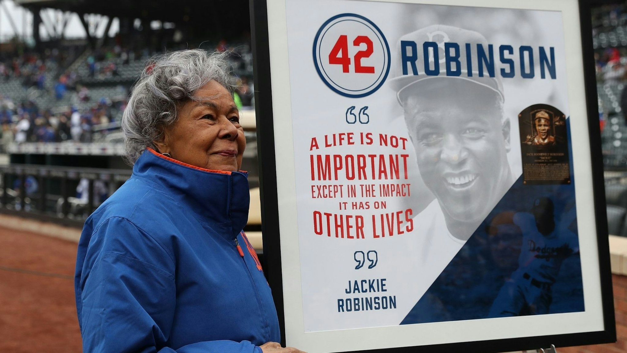 NEW YORK, NY - APRIL 15: Rachel Robinson, widow of Baseball player Jackie Robinson stands next to a mural of her late husband before the New York Mets play their game against the Milwaukee Brewers at Citi Field on April 15, 2018 in New York City. All players are wearing #42 in honor of Jackie Robinson Day.