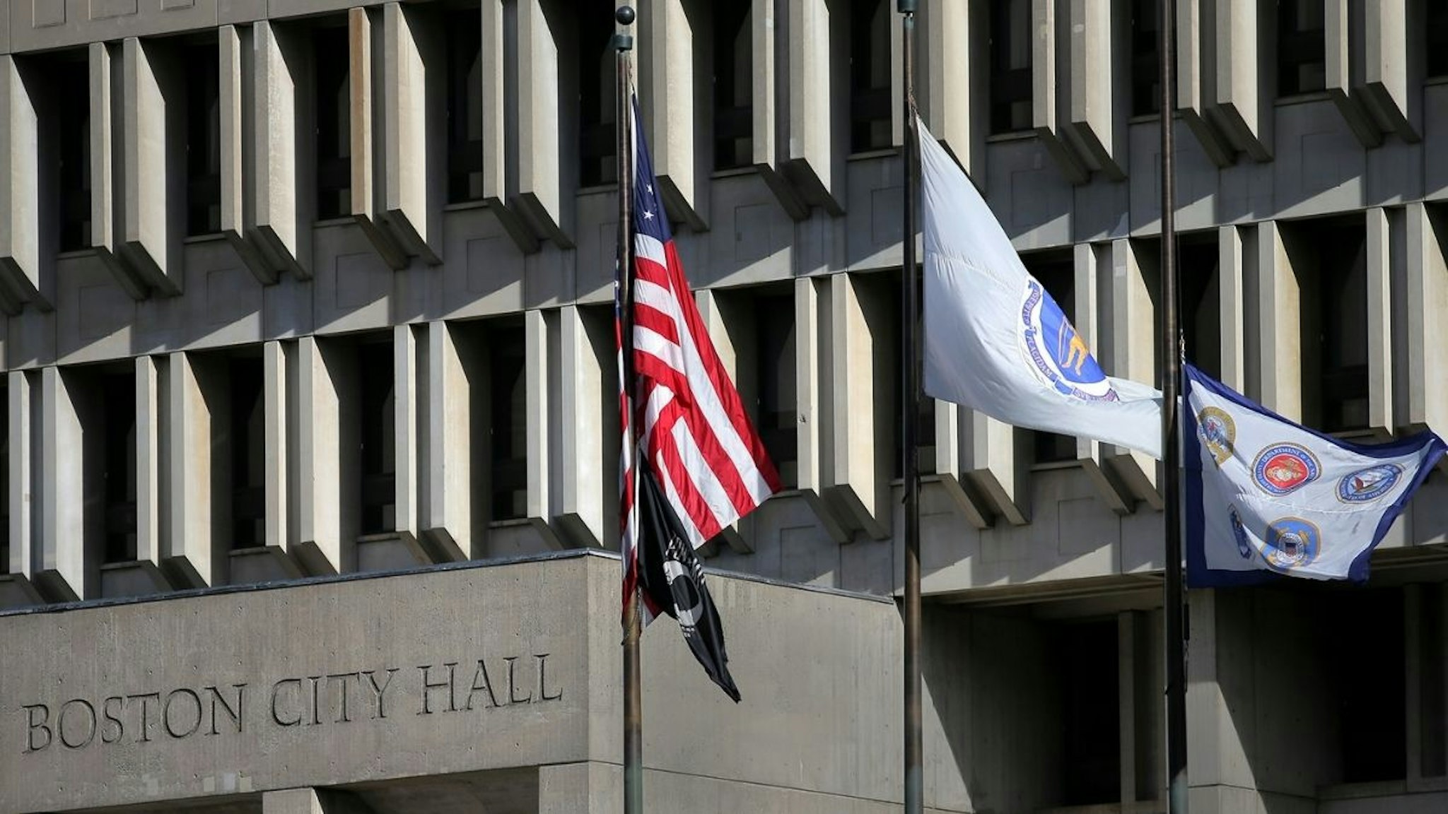 Flags fly above Boston City Hall on November 11, 2021.