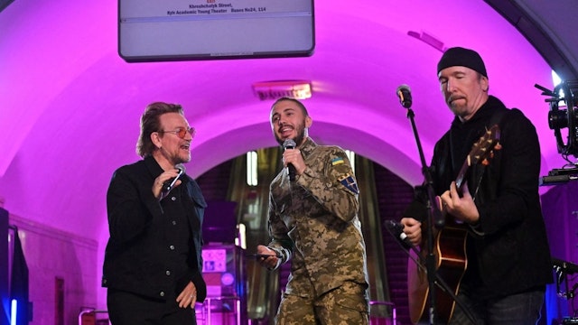 Bono (Paul David Hewson), Irish singer-songwriter, activist, and the lead vocalist of the rock band U2, Antytila (C), a Ukrainian musical band leader and now the serviceman in the Ukrainian Army Taras Topolia, and guitarist David Howell Evans aka 'The Edge' perform at subway station which is bomb shelter, in the center of Ukrainian capital of Kyiv on May 8, 2022.