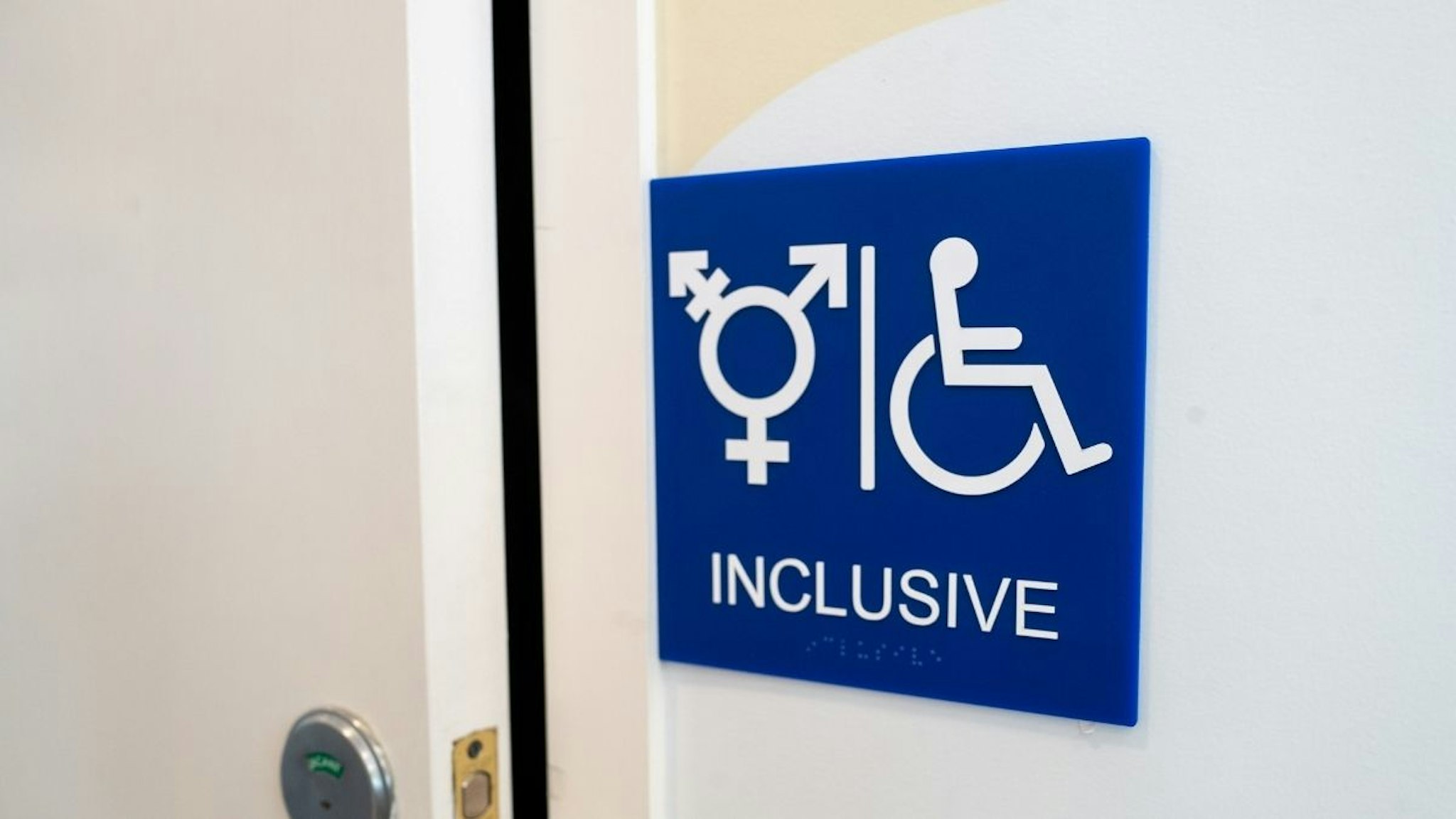 Sign for inclusive restroom, with symbol indicating male, female and transgender as well as handicapped symbol, part of LGBT rights initiatives in the Mission District neighborhood of San Francisco, California, July 18, 2019.
