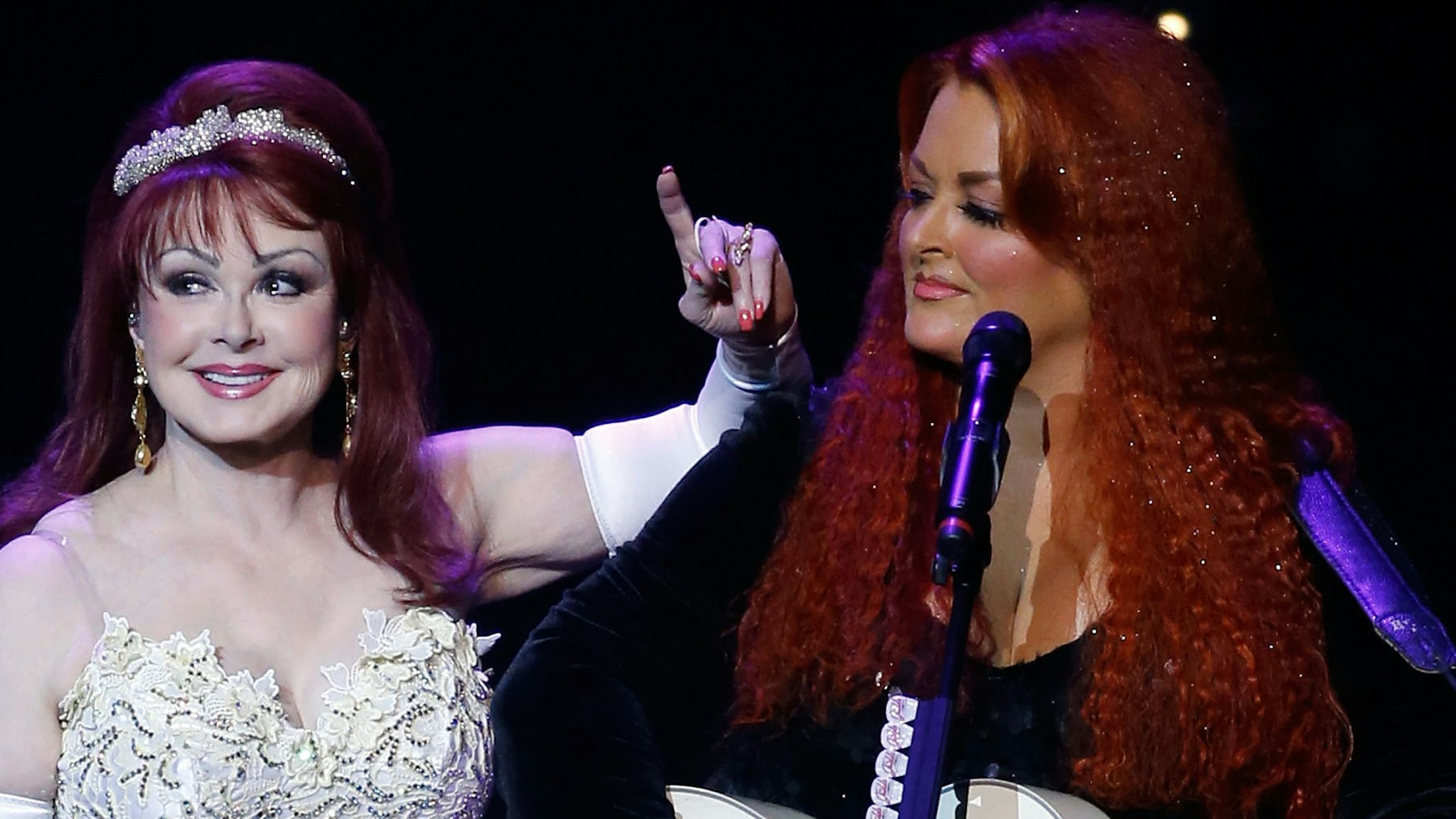 Recording artists Naomi Judd (L) and Wynonna Judd perform during the launch of their nine-show residency "Girls Night Out" at The Venetian Las Vegas on October 7, 2015 in Las Vegas, Nevada.