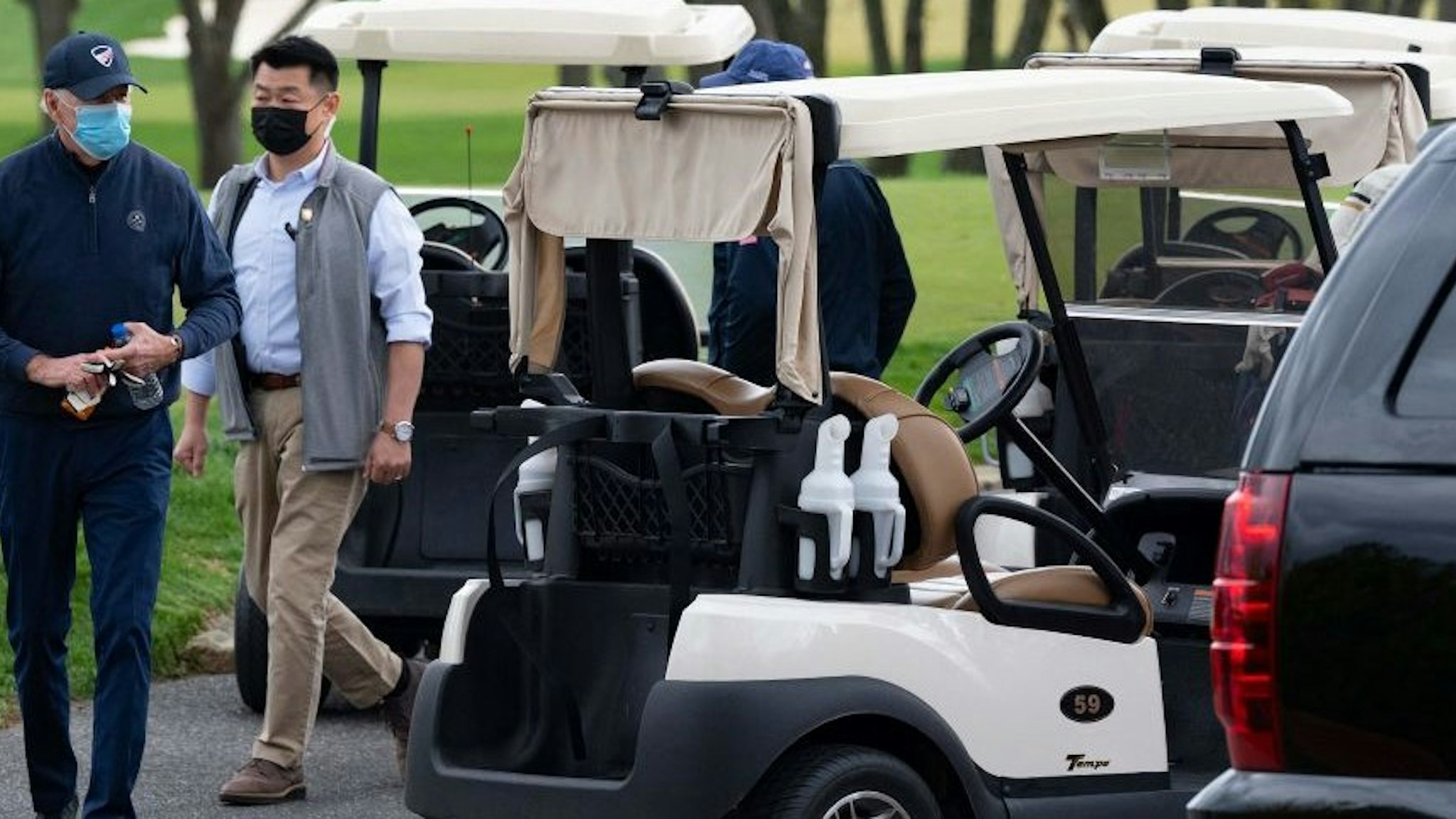 US President Joe Biden leaves his cart after a round of golf at Wilmington Country Club in Wilmington, Delaware, on April 17, 2021. - President Joe Biden played golf for the first time in his presidency Saturday, hitting the fairways in his home city of Wilmington. (Photo by JIM WATSON / AFP) (Photo by