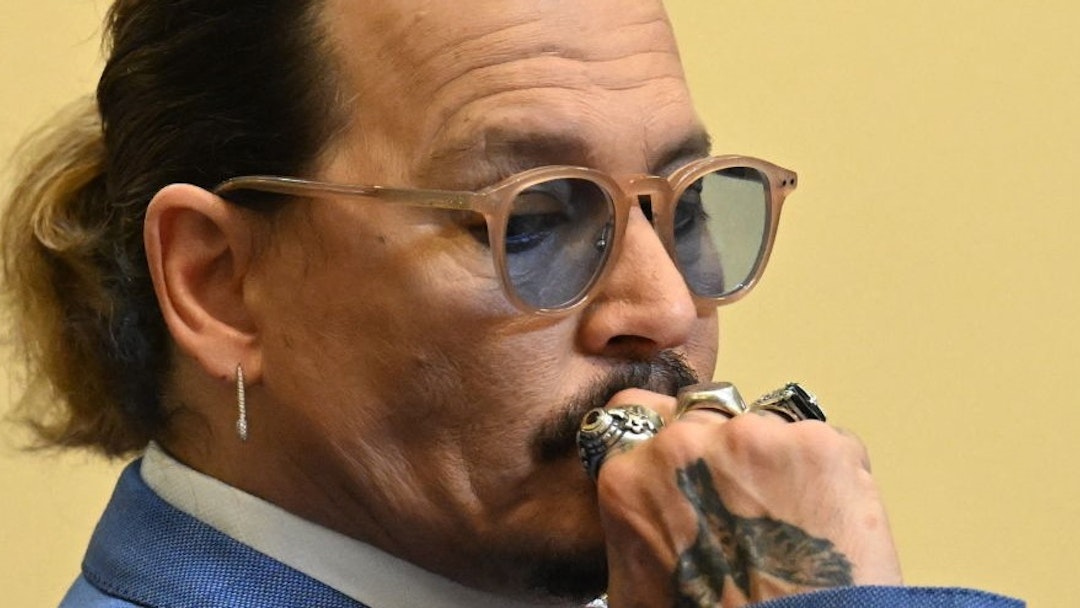US actor Johnny Depp listens during trial at the Fairfax County Circuit Courthouse in Fairfax, Virginia, on May 24, 2022. - Actor Johnny Depp is suing ex-wife Amber Heard for libel after she wrote an op-ed piece in The Washington Post in 2018 referring to herself as a public figure representing domestic abuse. (Photo by JIM WATSON / POOL / AFP) (Photo by