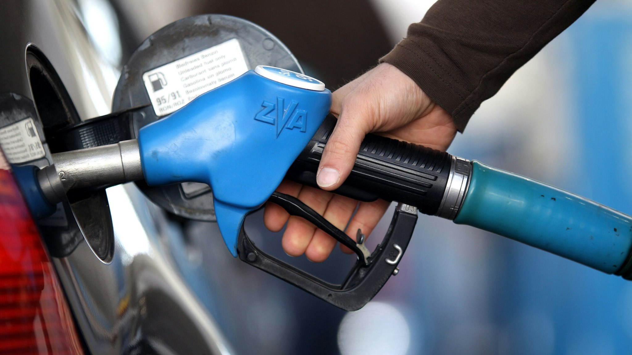 MUNICH, GERMANY - MARCH 23: In this photo illustration a man refuels his car on March 23, 2010 in Munich, Germany. German President Horst Koehler said higher petrol prices could help make Germans become more environmentally conscious.