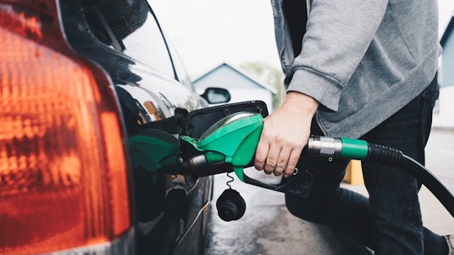 Midsection of man refueling car at gas station - stock photo Maskot via Getty Images