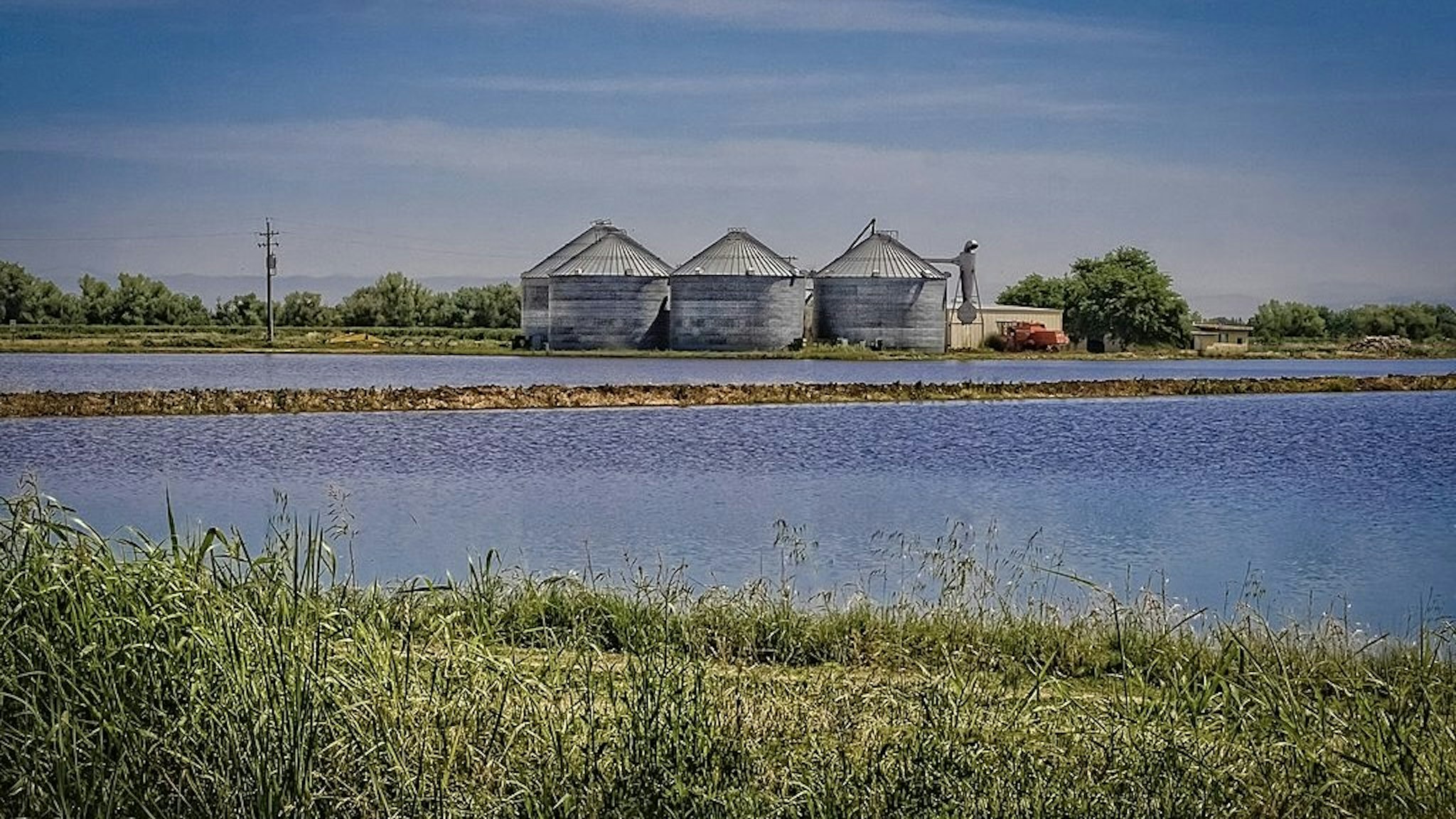 Agriculture Tech Silos next to flooded rice paddies, Sacramento Valley, California. Mardis Coers / Contributor via Getty Images
