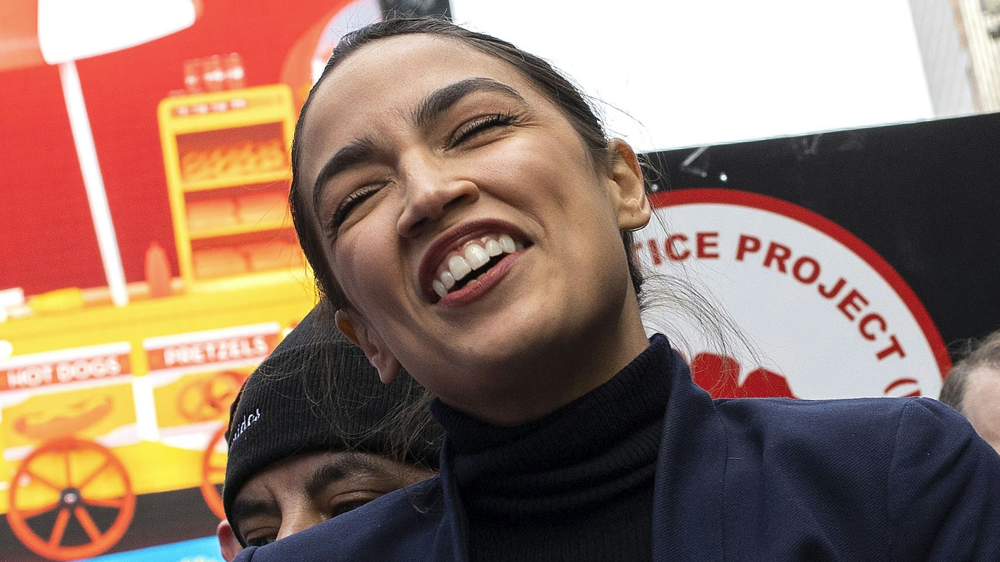 NEW YORK, NEW YORK - JANUARY 23: Congresswoman Alexandria Ocasio-Cortez joins delivery workers to celebrate the passage of legislation by the New York City Council guaranteeing them basic labor rights such as wages, tips, and rest areas, January 23, 2022 in Times Square, New York City.