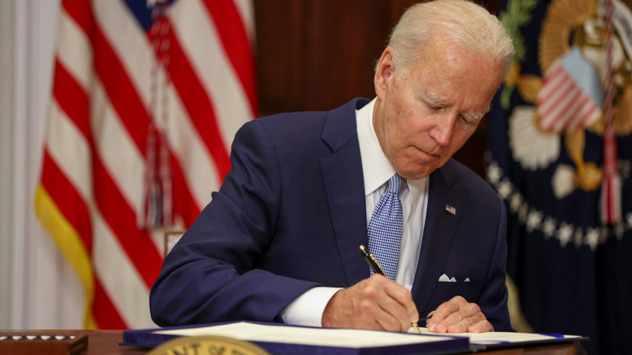 WASHINGTON, DC - JUNE 25: U.S. President Joe Biden signs the Bipartisan Safer Communities Act into law in the Roosevelt Room of the White House on June 25, 2022 in Washington, DC. The legislation is the first new gun regulations passed by Congress in more than 30 years.