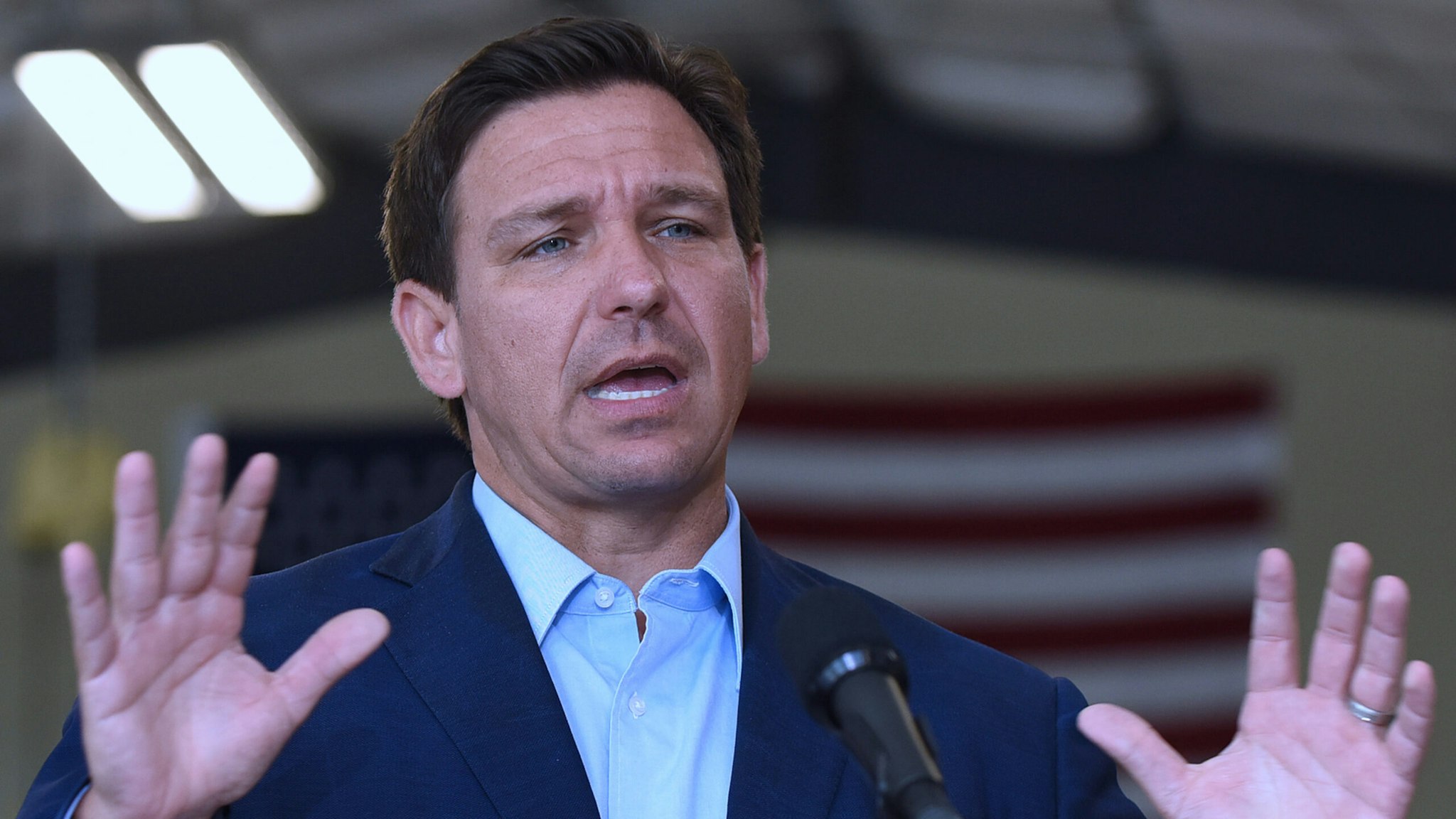 Florida Governor, Ron DeSantis speaks at a press conference at the Eau Gallie High School aviation hangar.