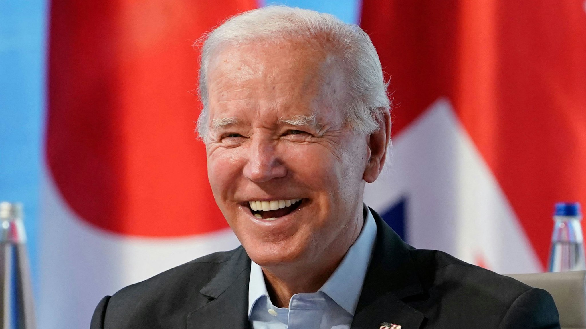 US President Joe Biden smiles at the start of a lunch with Representatives of Seven rich nations (G7) and Outreach guests during their fifth working session about Investing in a better future: Climate, Energy, Health on June 27, 2022 at Elmau Castle, southern Germany, during the G7 Summit. - G7 leaders are under pressure to hold fast to climate pledges when they meet in Bavaria from June 26 to 28, as Russia's energy cuts trigger a dash back to planet-heating fossil fuels.